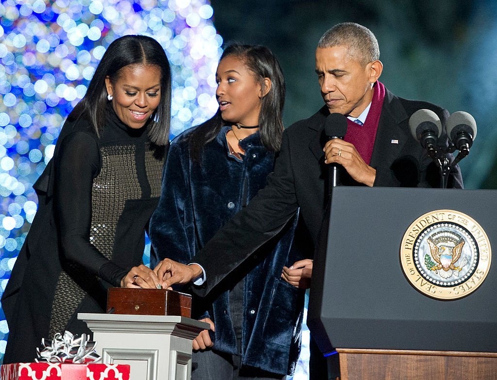President Barack Obama, first lady Michelle Obama and Sasha Obama trip the switch at the National Christmas Tree Lighting on the Ellipse | Photo: Getty Images