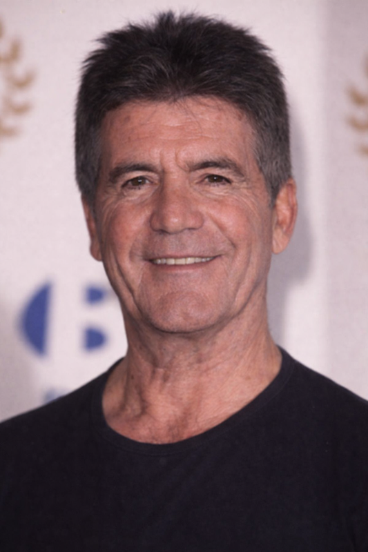 A close-up portrait of Simon Cowell showing natural lines across the forehead and around the eyes, with dark hair, a warm smile, and visible sun-weathered skin. | Source: ChatGPT