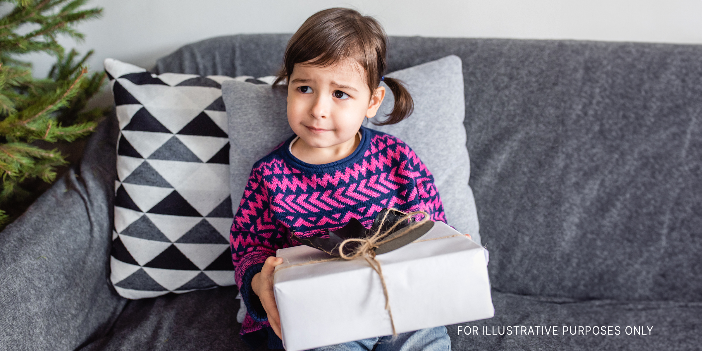 A young girl with a present | Source: Shutterstock