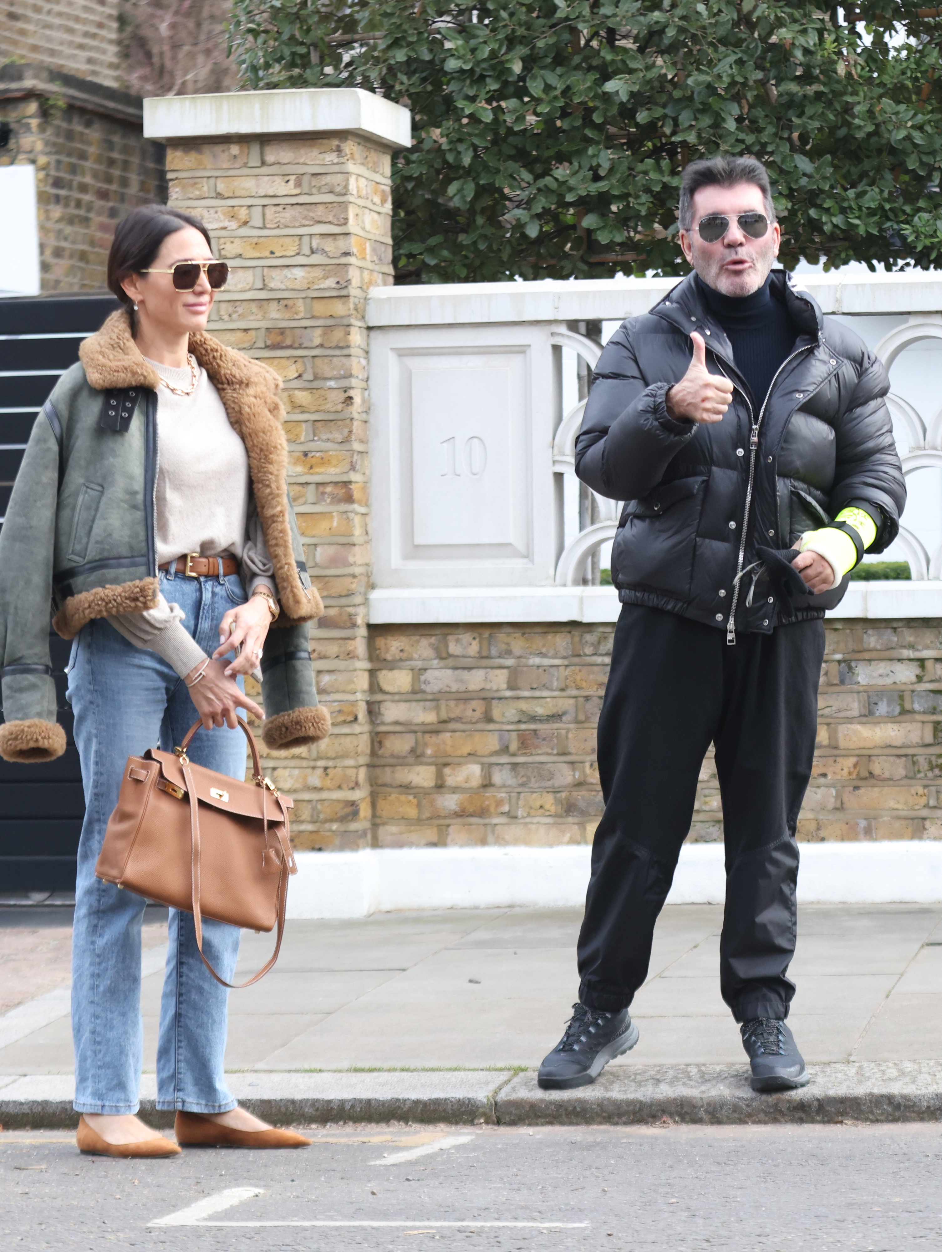 Simon Cowell and his partner, Lauren Silverman outside their home in London's Holland Park on February 2, 2022 | Source: Getty Images