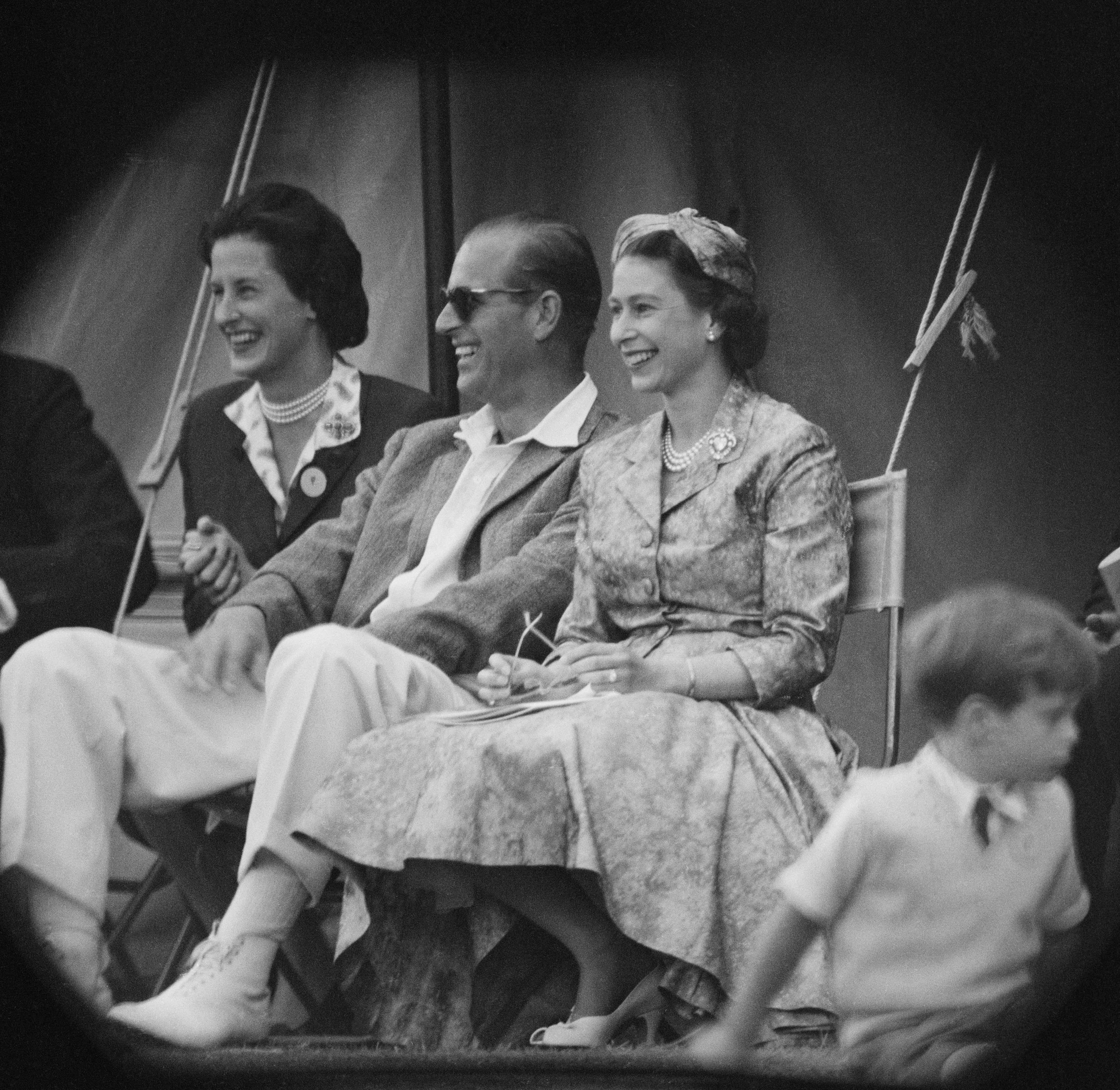 Queen Elizabeth II and Prince Philip watch a cricket match at Highclere Castle in Hampshire, in 1958 | Source: Getty Images