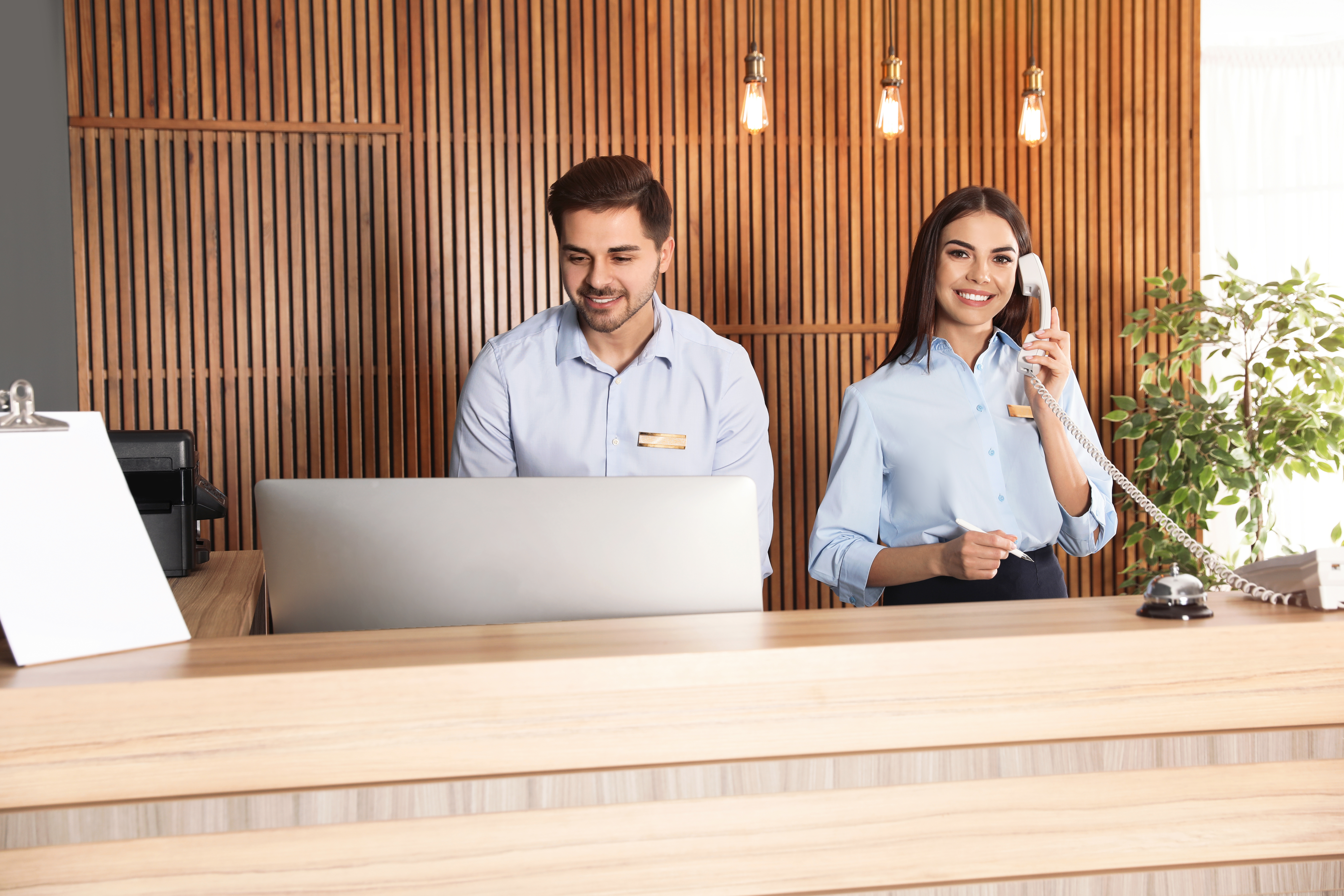 Receptionist taking a call | Source: Shutterstock