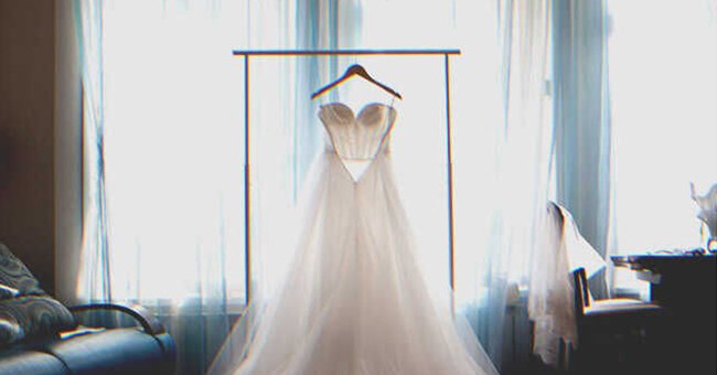 A wedding dress by a window | Source: Shutterstock
