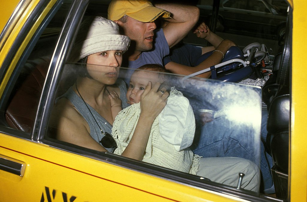 Demi Moore holding her daughter, Rumer Willis, alongside actor, Bruce Willis. | Source: Ron Gallela/Getty Images