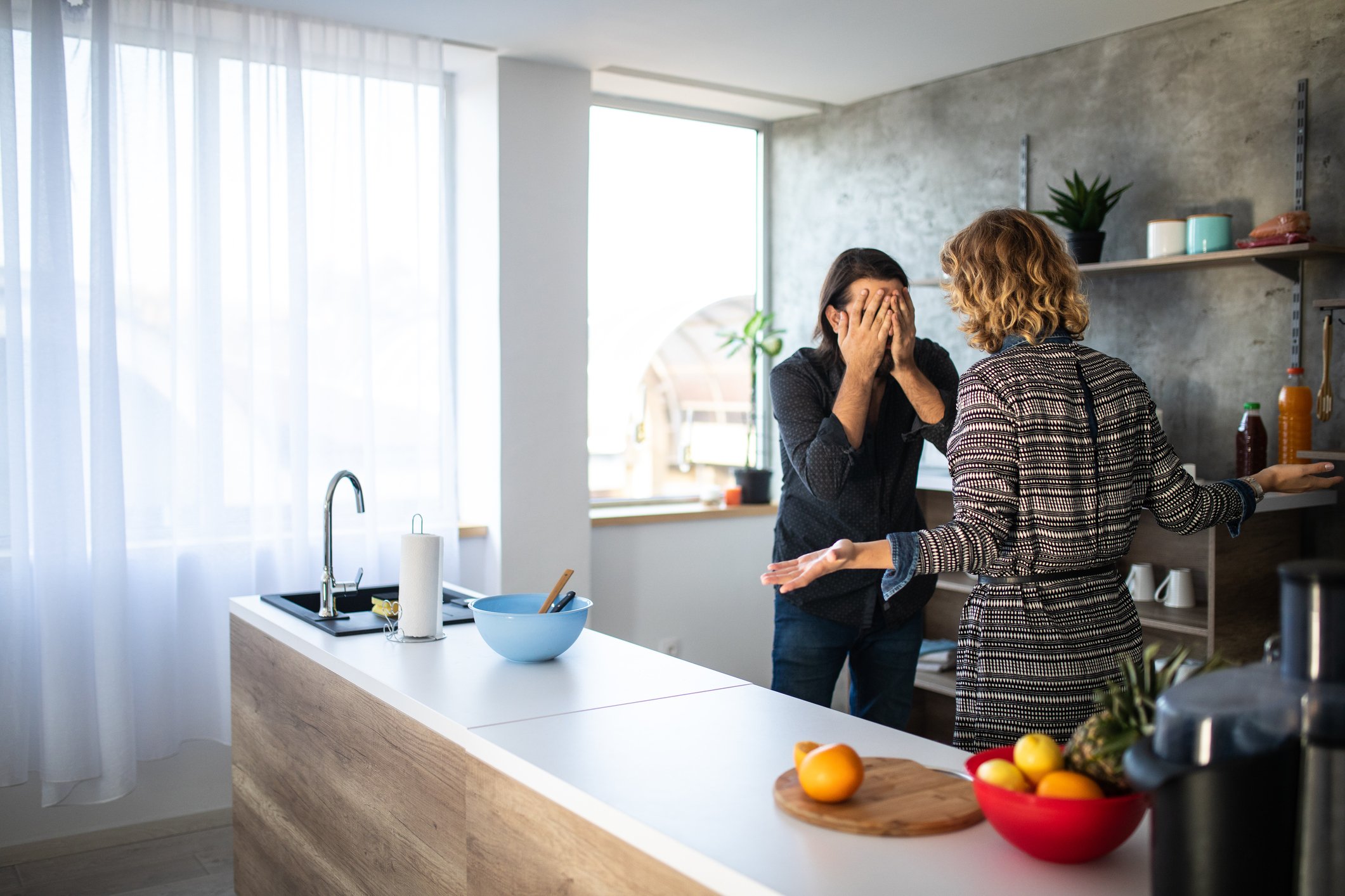 A man and a woman having argument in the kitchen in the morning | Photo: Getty Images