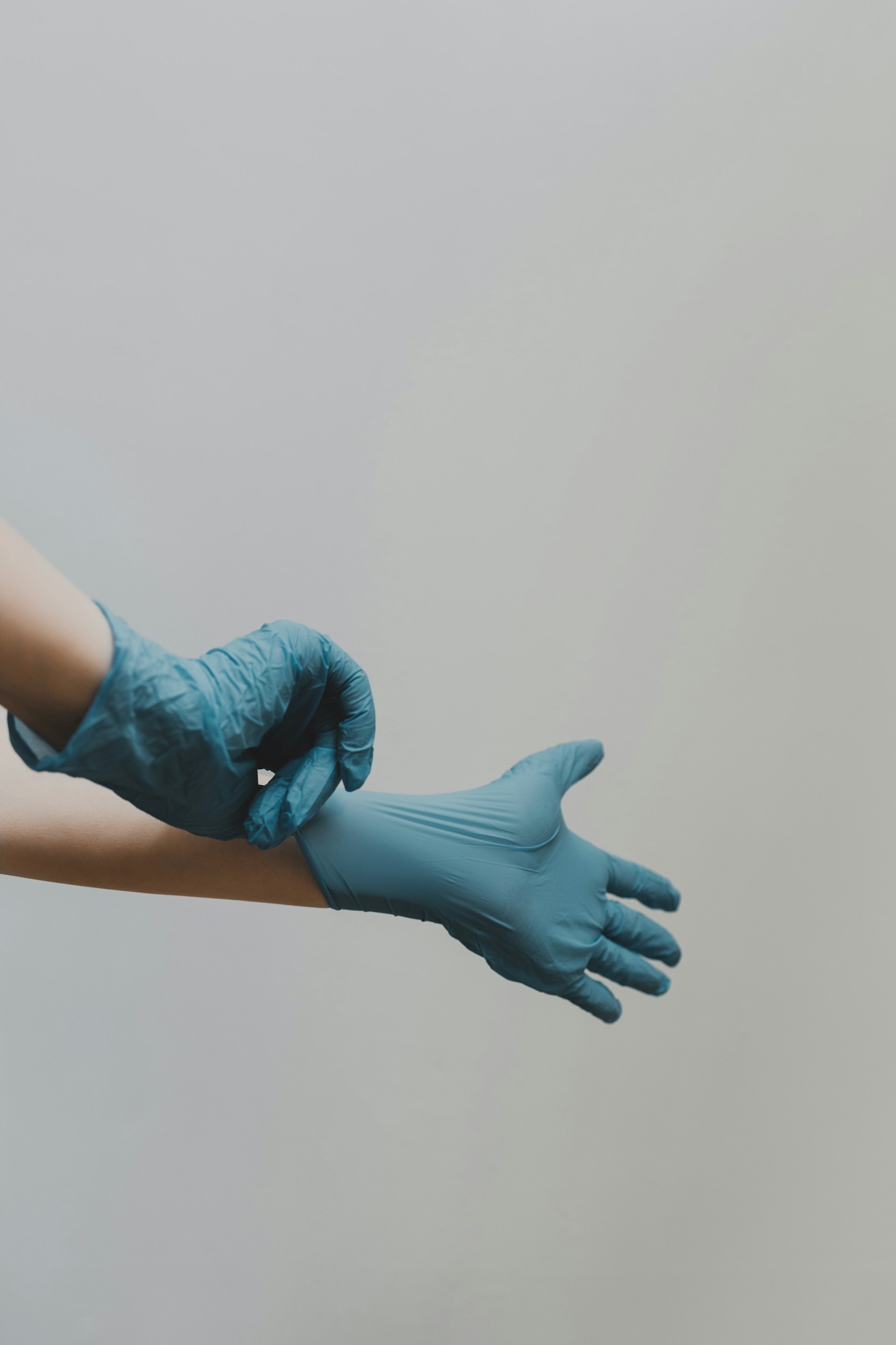 A doctor wearing surgical gloves | Source: Unsplash