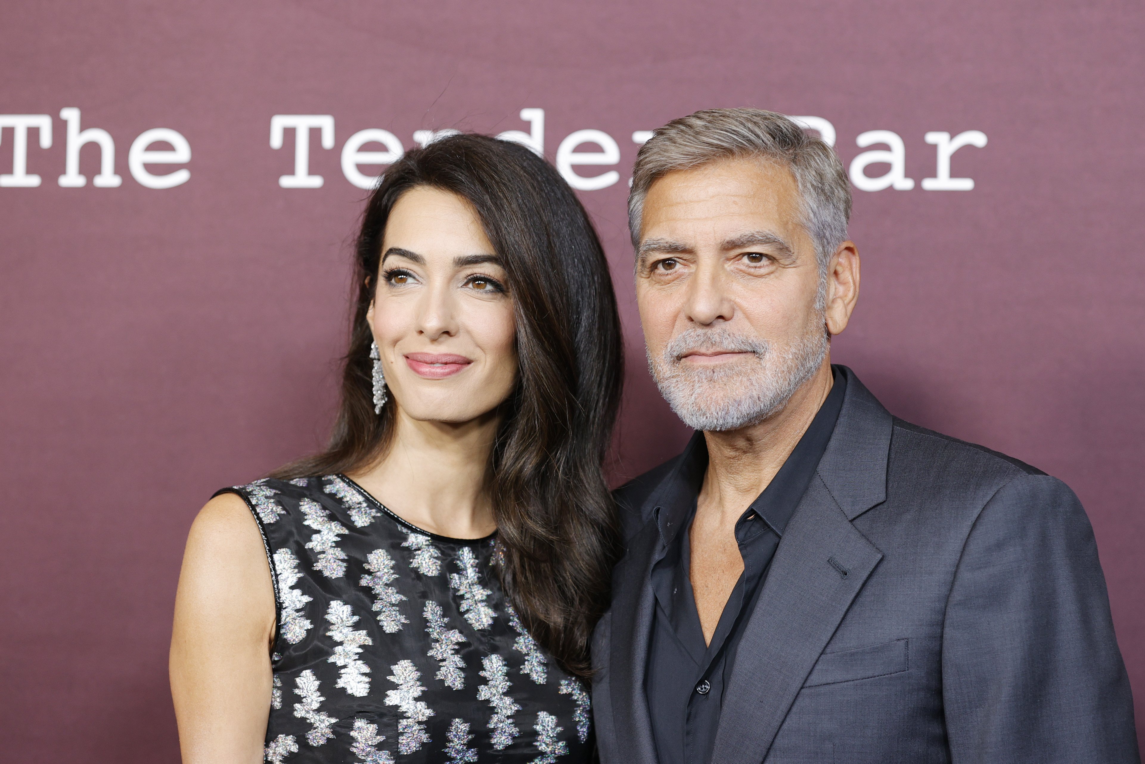 Amal Clooney and husband George Clooney attend the Los Angeles premiere of "The Tender Bar" at DGA Theater Complex on October 03, 2021 in Los Angeles, California. / Source: Getty Images