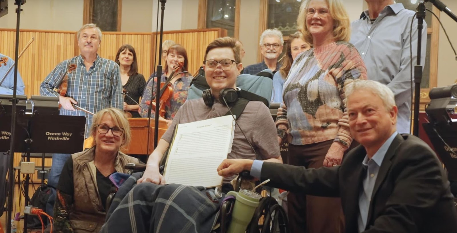 Gary and Mac Sinise posing for a photo with others. | Source: YouTube/Mac Sinise