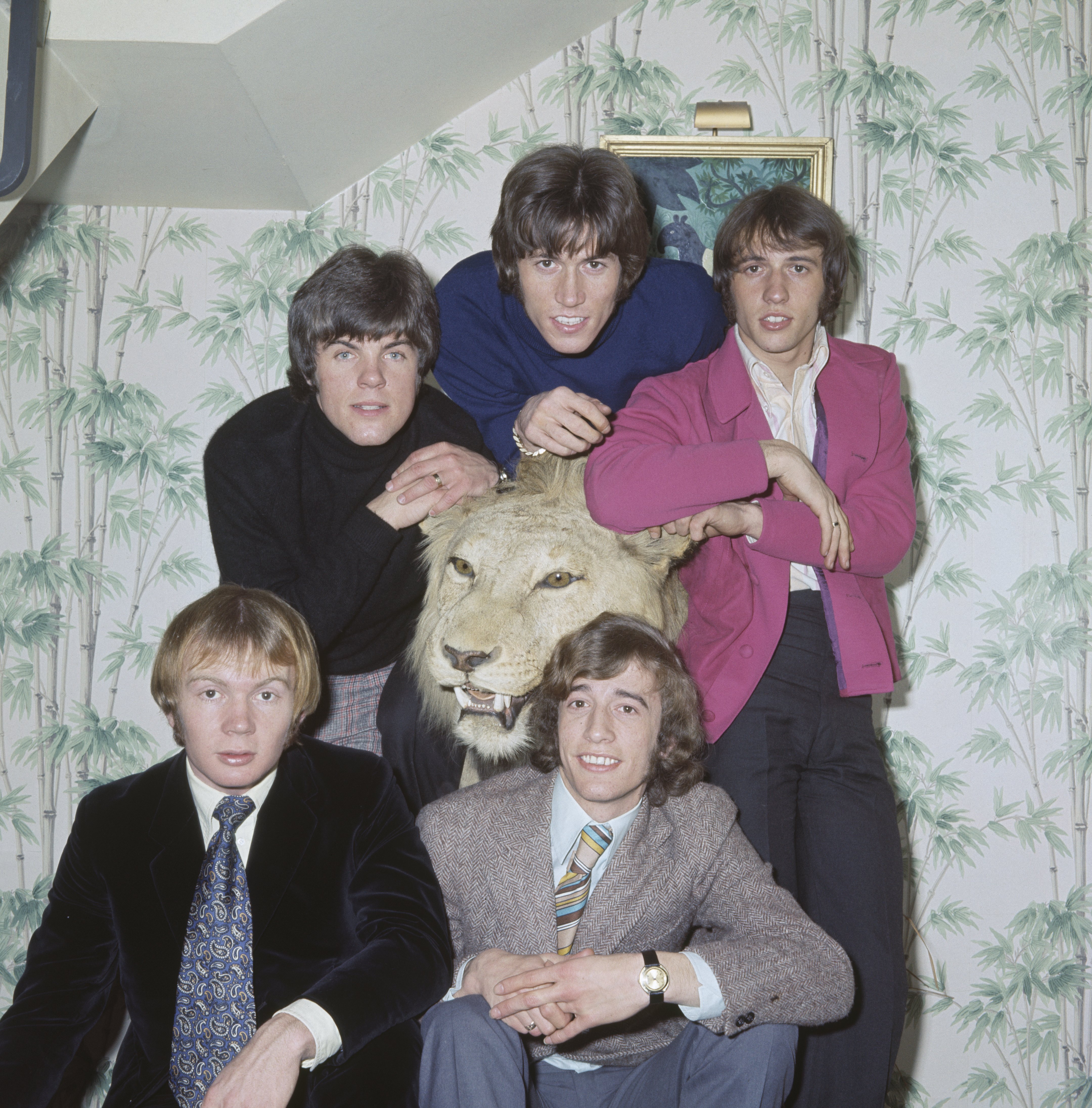 The Bee Gees pose for a picture in 1967 with friends and their brother Andy Gibb | Source: Getty Images 