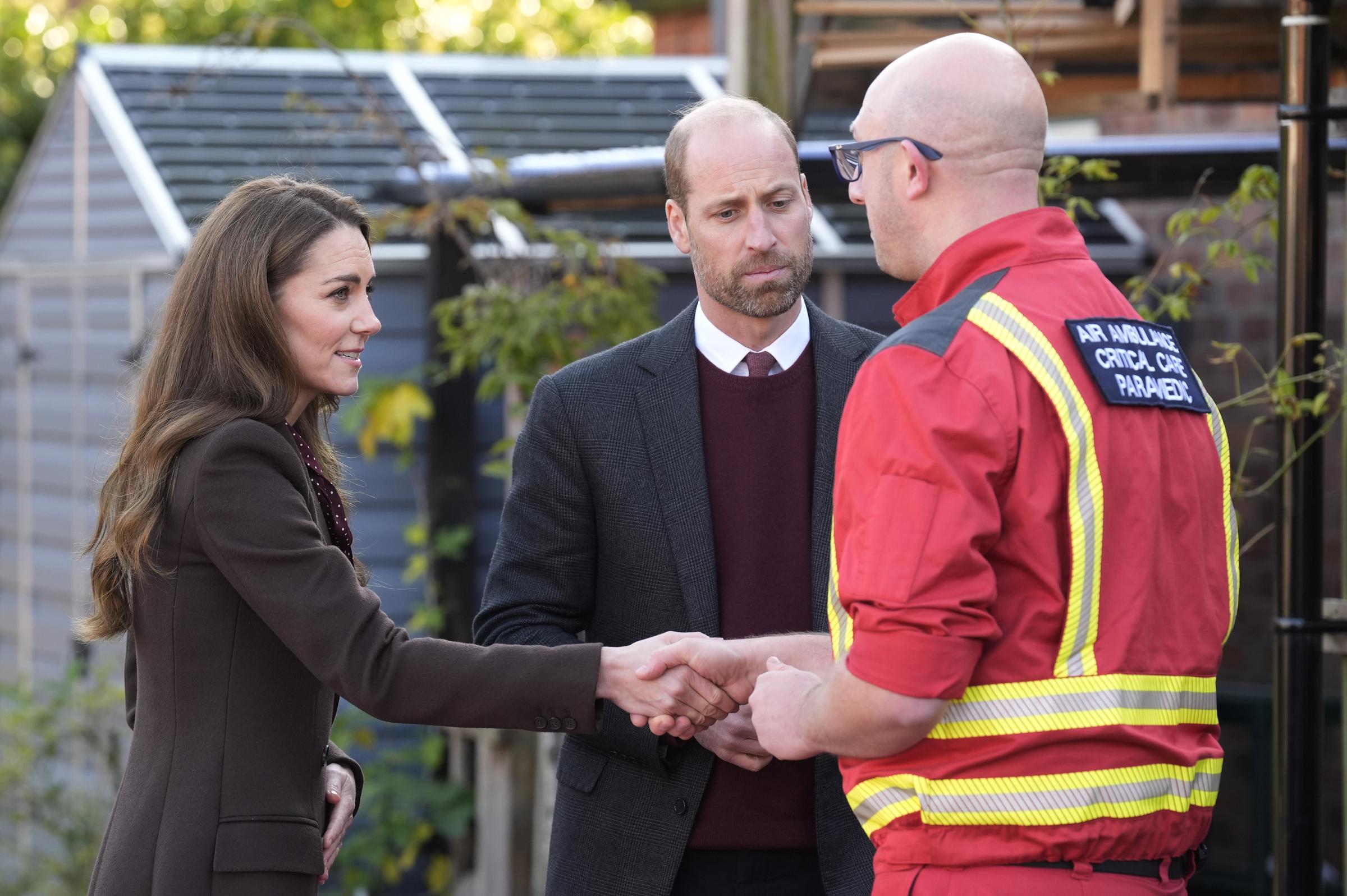 Prince William and Catherine, Princess of Wales speak to a member of the emergency services during a visit to Southport, north west England on October 10, 2024 | Source: Getty Images