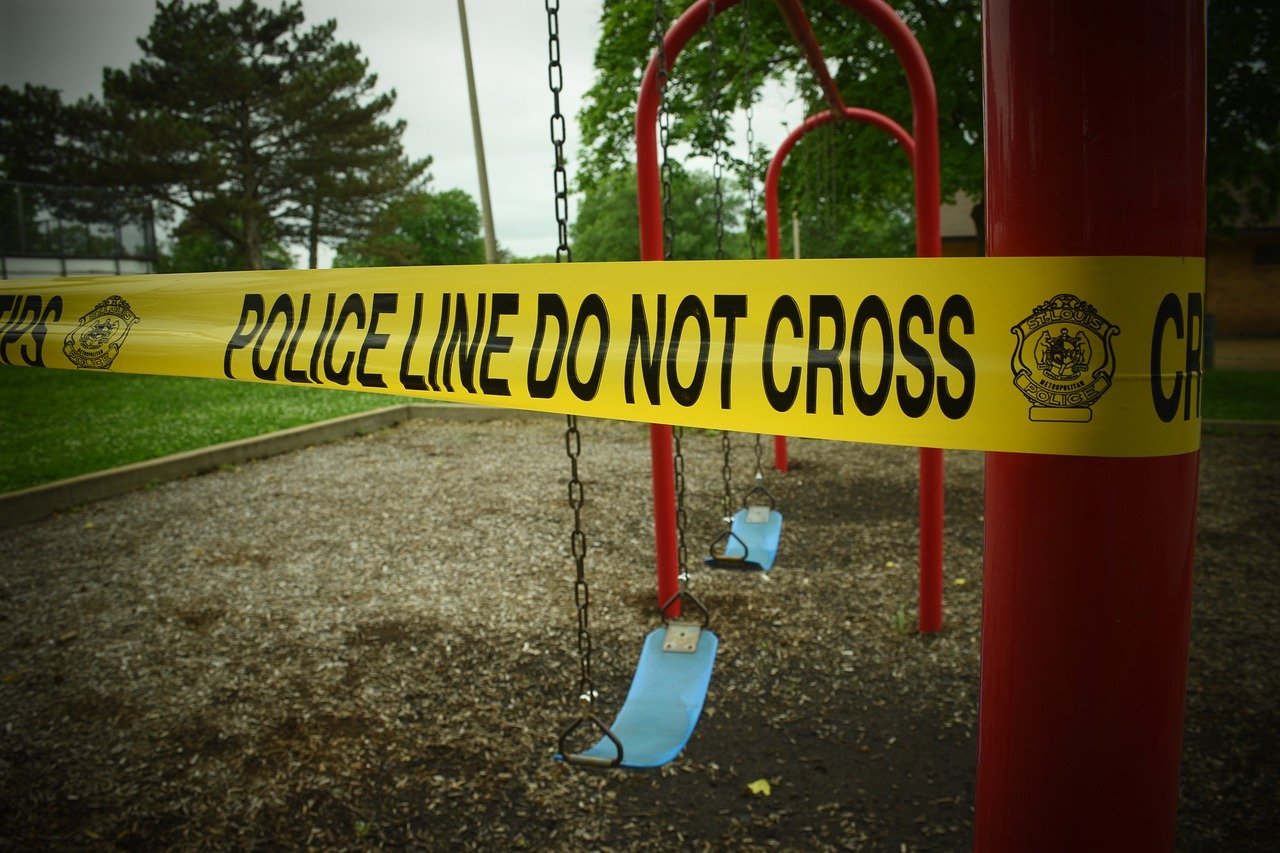 A police cautionary tape wound up at a playground | Photo: Pixabay/Allison Barnett
