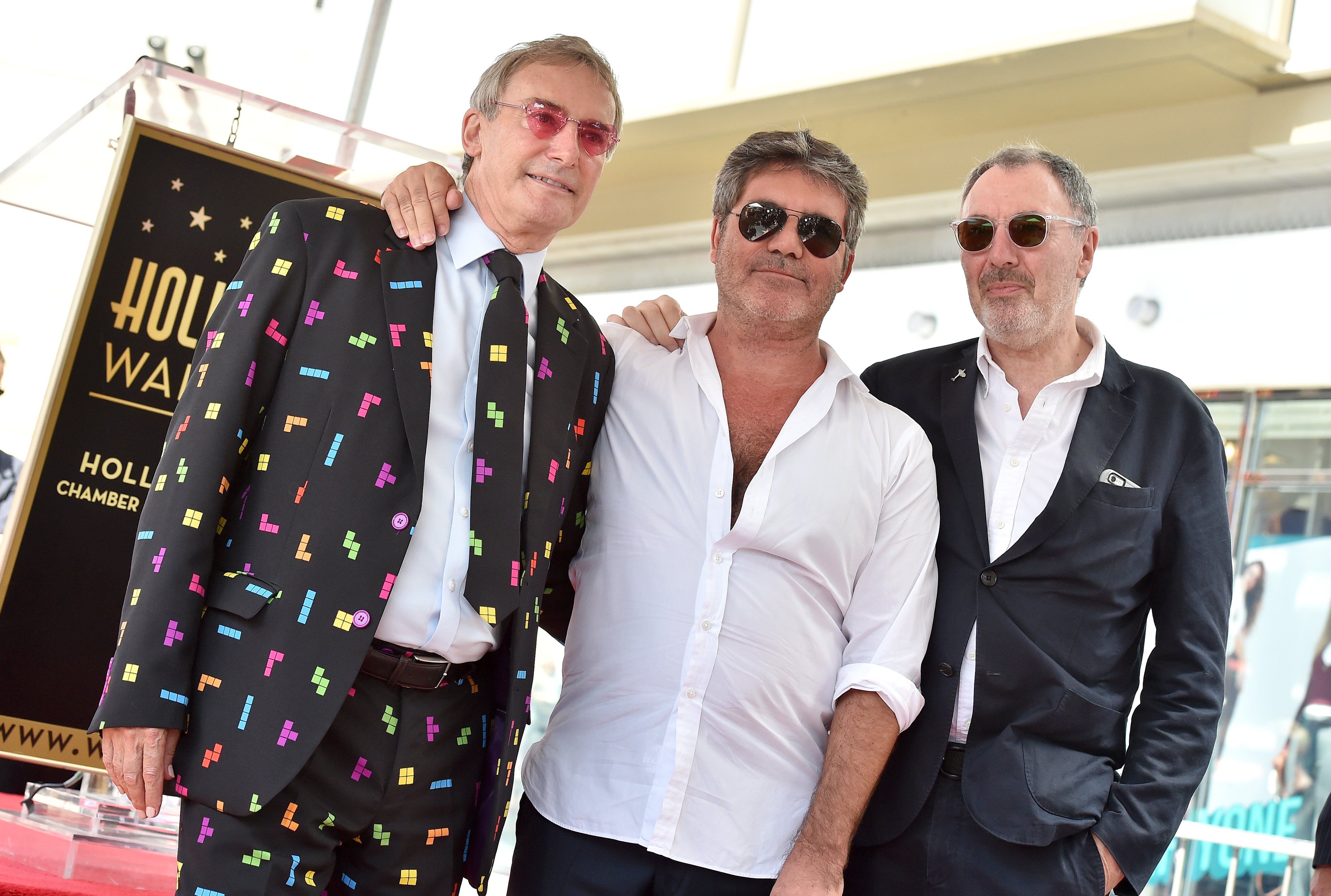  Simon Cowell with brothers Nicholas Cowell and Tony Cowell at the ceremony honoring him with a star on the Hollywood Walk of Fame in 2018 in Hollywood. | Source: Getty Images