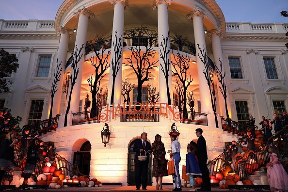 President Donald Trump and first lady Melania Trump hand out candy to trick-or-treaters during a Halloween at the White House event at the South Portico of the White House. | Photo: Getty Images
