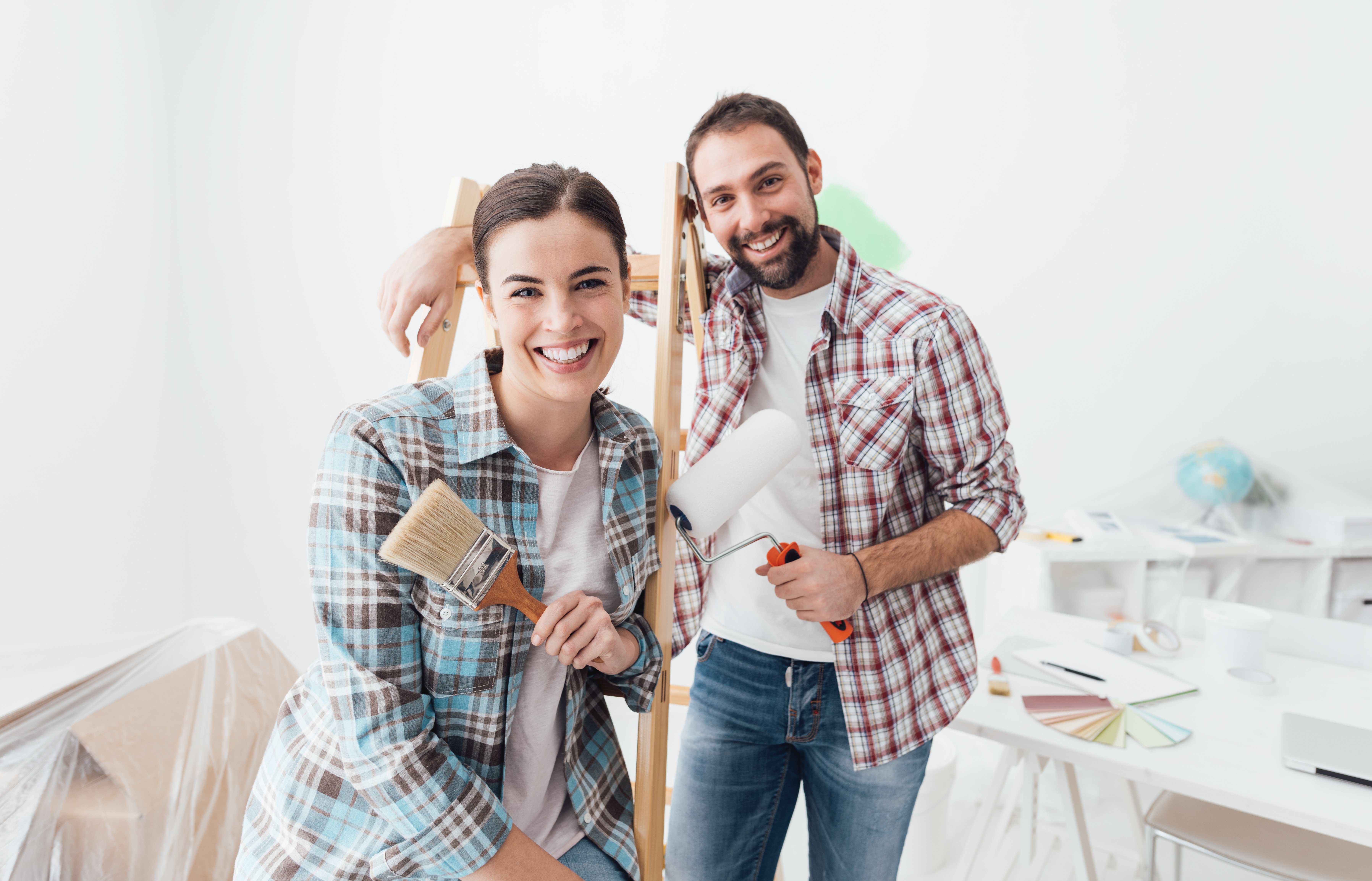 A man and woman painting their home. | Photo: Shutterstock