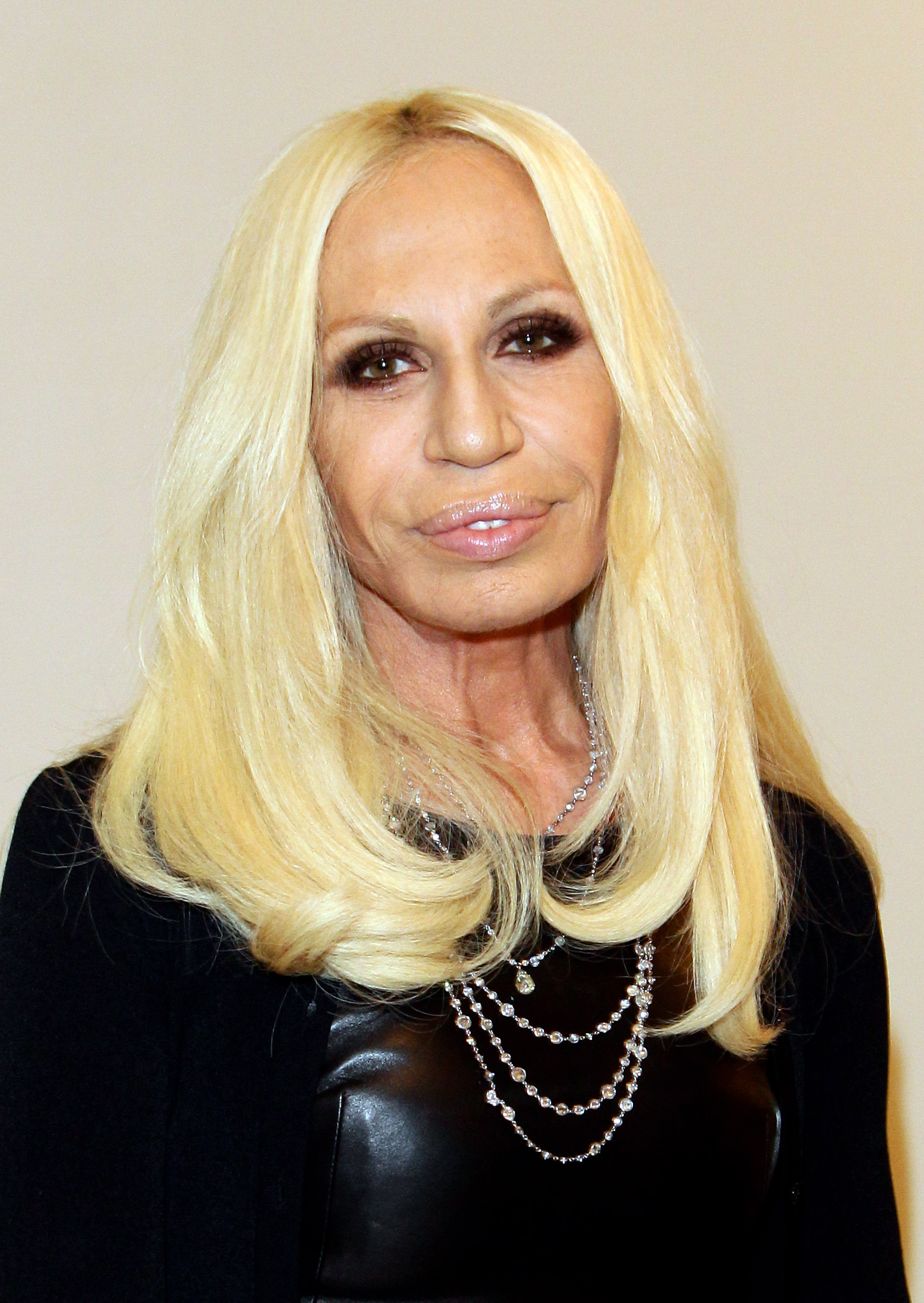 Donatella Versace, 55, attended the launch of "I Capricci Della Moda" on December 10, 2010, in Milan, Italy. Her face displayed fine wrinkles around the eyes, significant volume of her lips, and a uniformly stretched skin texture across her cheeks.