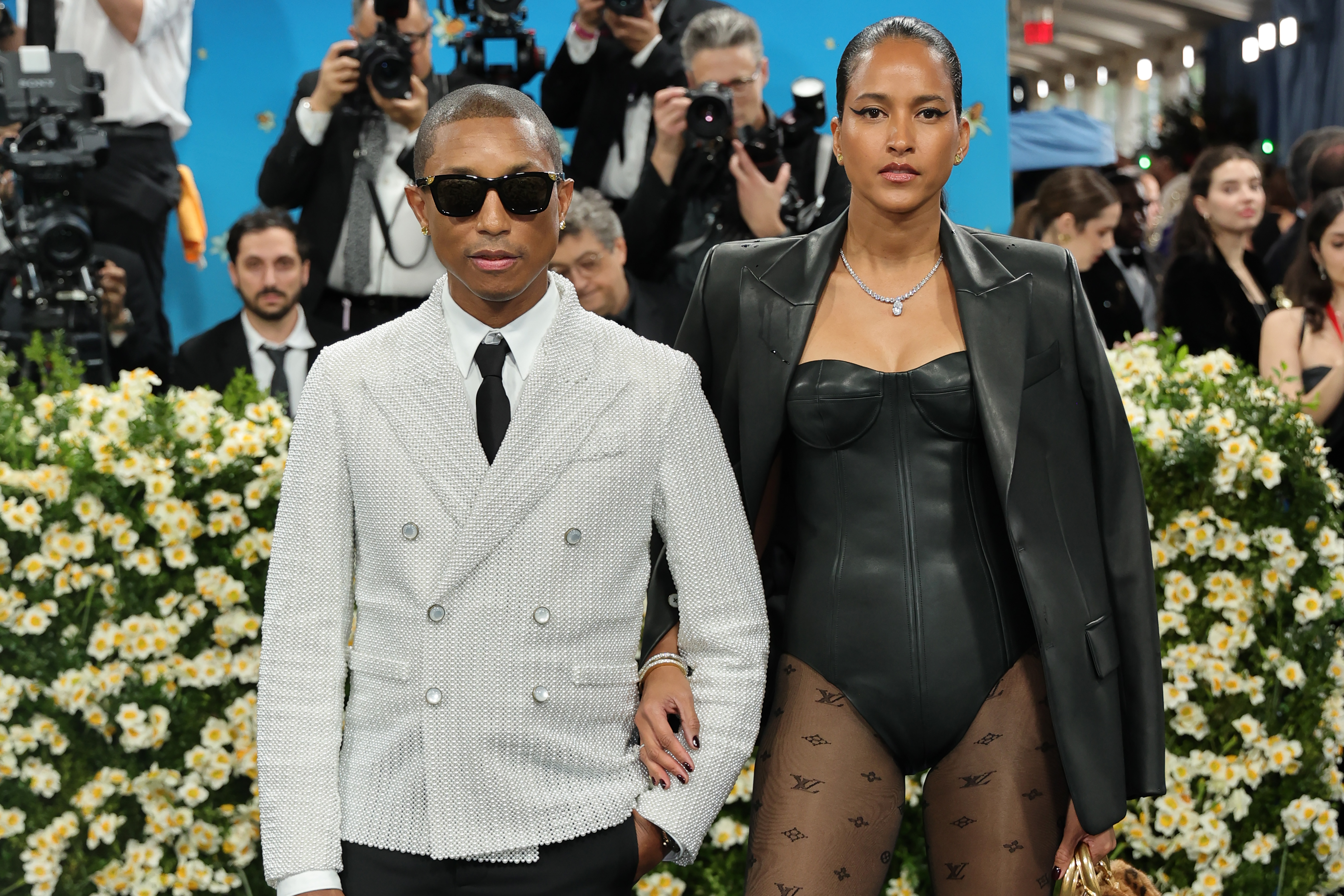Pharrell Williams and Helen Lasichanh pose at the Met Gala Celebrating "Superfine: Tailoring Black Style" on May 5, 2025, in New York City. | Source: Getty Images