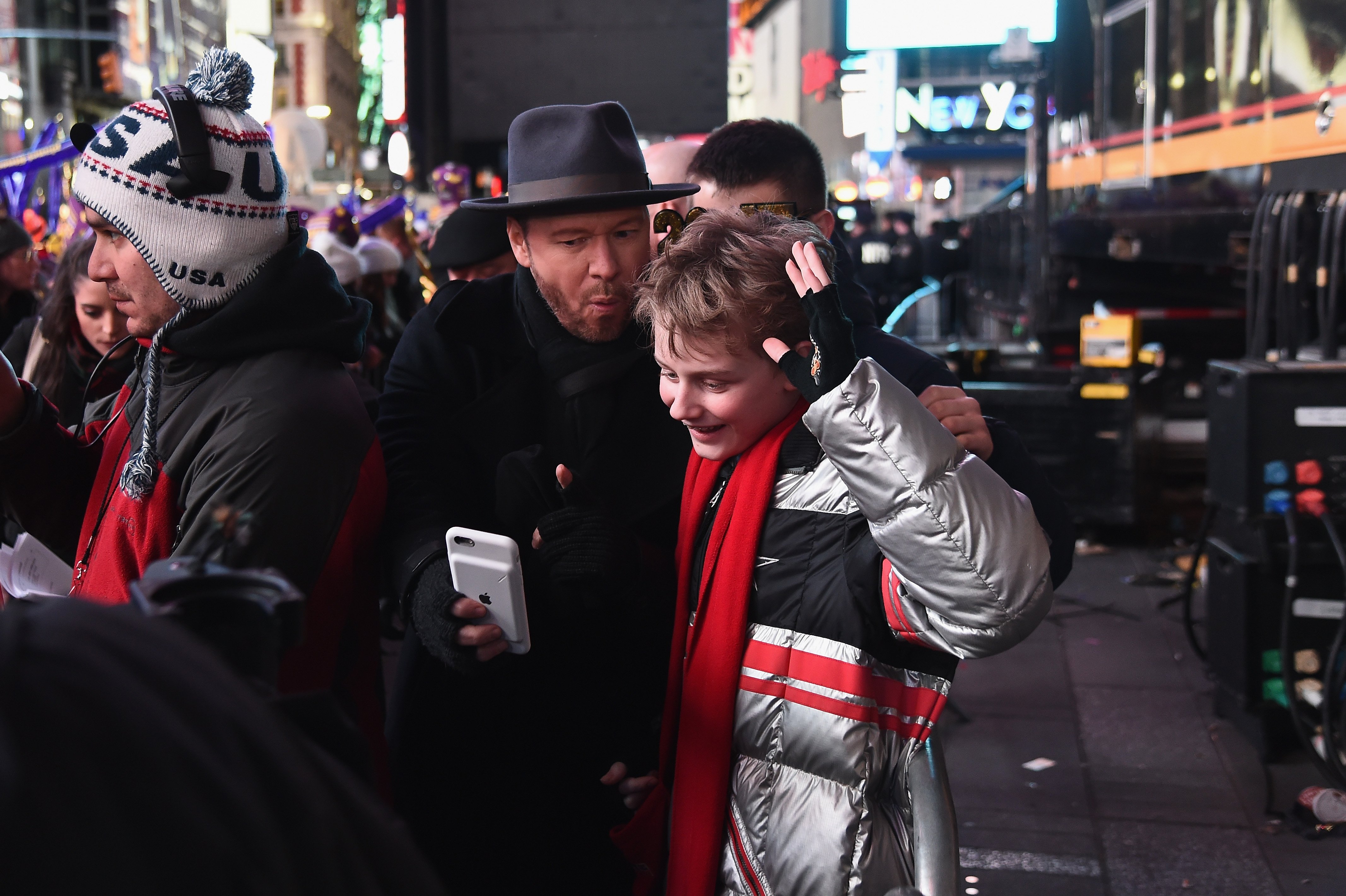 Donnie Wahlberg and Evan Joseph Asher pose for selfies during Dick Clark's New Year's Rockin' Eve 2017 at Times Square on December 31, 2016 in New York City | Source: Getty Images 