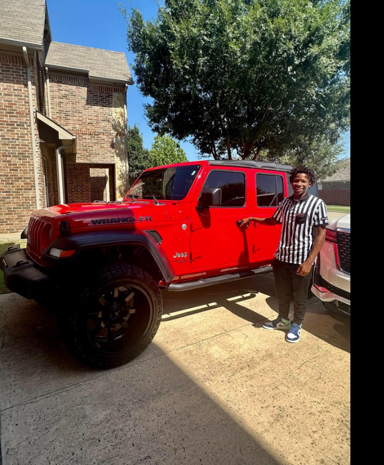 Karmelo Anthony poses next to a red Jeep Wrangler before the fatal stabbing case that would later place him at the center of national headlines. | Source: Facebook/Drew Anthony