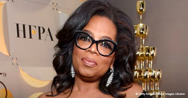 Oprah looks slimmer than ever in crisp white pants & flirty top with bows all over