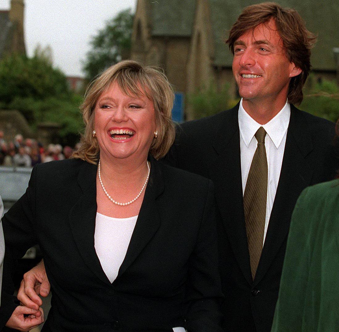 Judy Finnigan and Richard Madeley are pictured leaving St Michael's Church in Sunderland on 26 April 1997, smiling and visibly at ease as they attend the wedding of their "This Morning" colleague Denise Robertson — a joyful public appearance that captured the pair's warmth and close ties both within and beyond the programme.