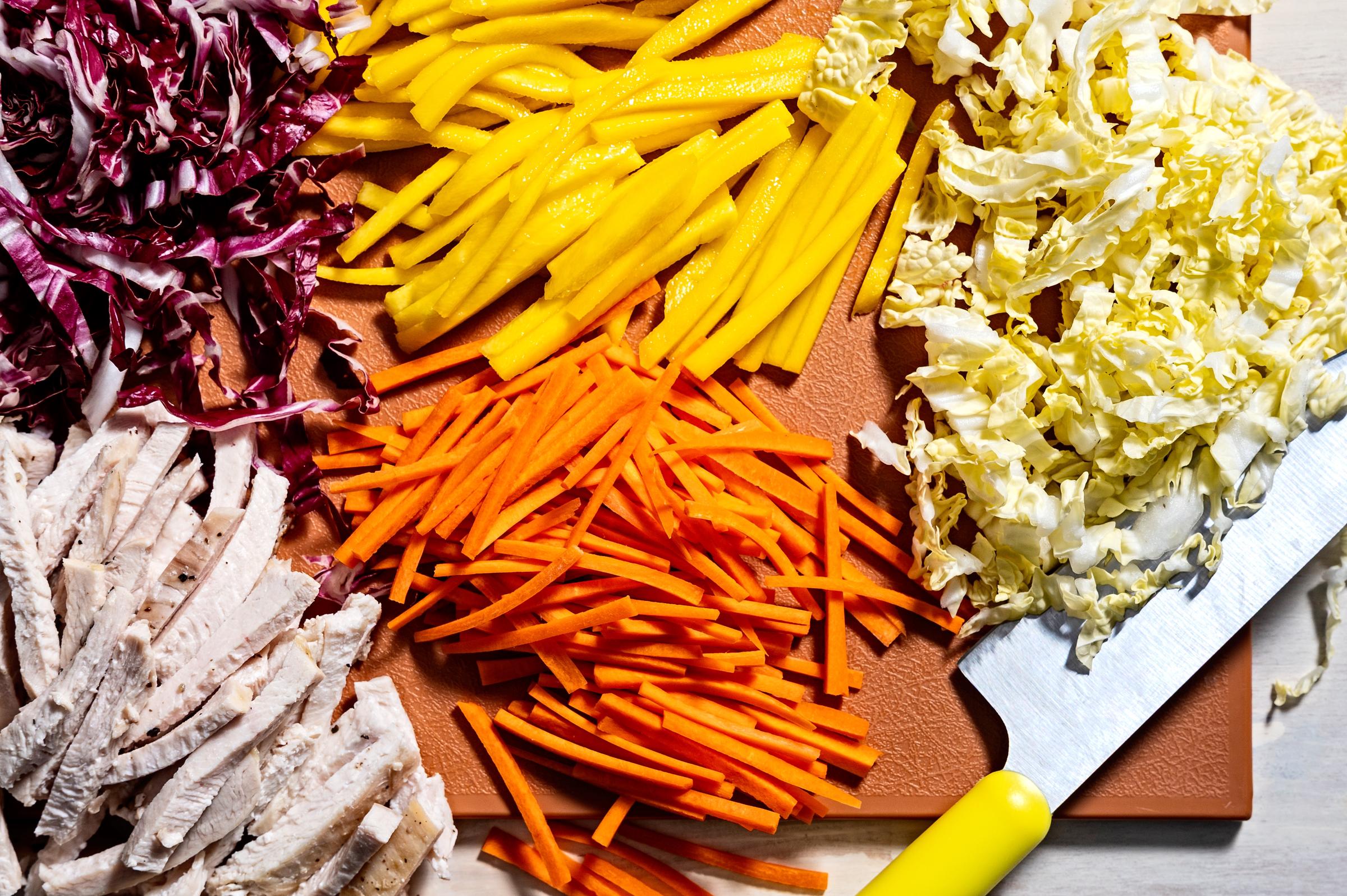 Radicchio, mango, cabbage, carrots, and cut-up chicken | Source: Getty Images