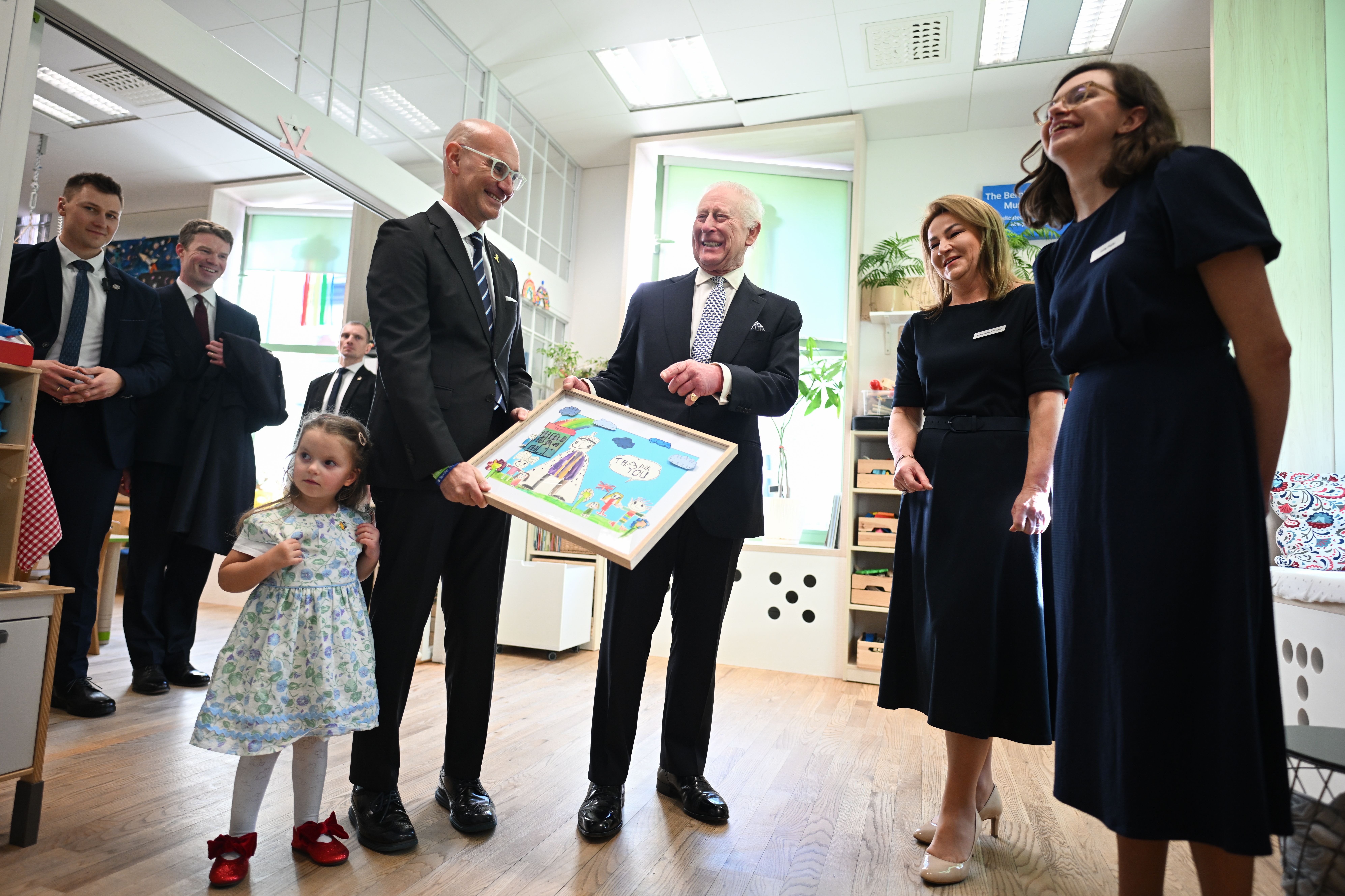 King Charles III is presented with a painting from children thanking him for his visit to the Jewish Community Centre in Krakow, Poland, on January 27, 2025 | Source: Getty Images