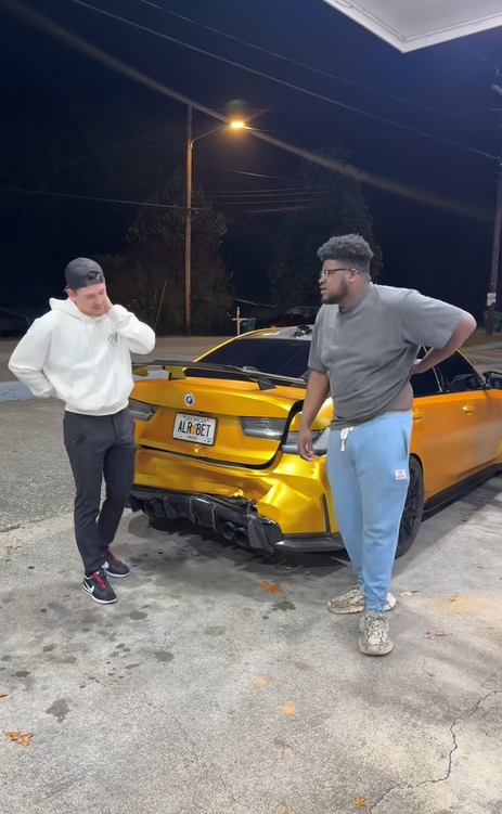 Marquay Collins and a companion stand in front of the damaged rear of his yellow car after the crash, posted on November 14, 2025. | Source: Tiktok/marquaythegoat
