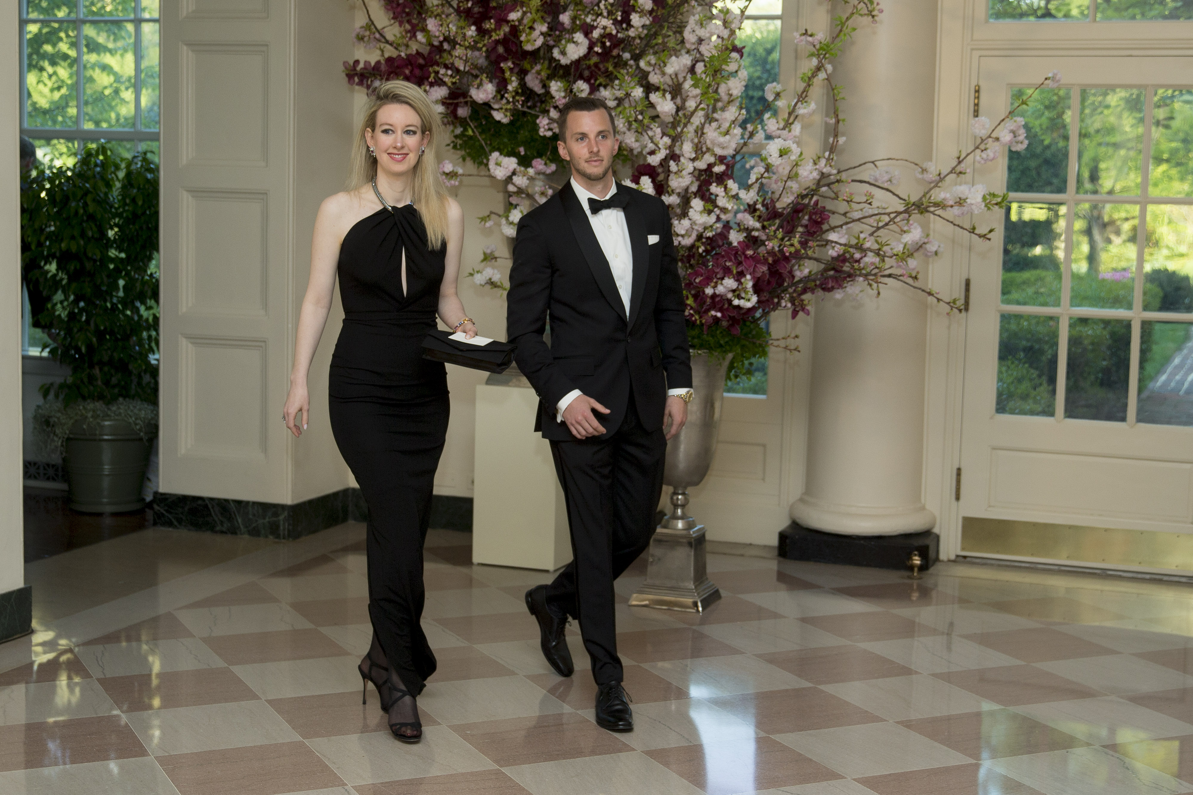 Elizabeth Holmes, founder and chief executive officer of Theranos Inc., left, and her brother Christian Holmes at the White House in Washington, D.C., U.S., on Tuesday, April 28, 2015. | Source: Getty Images