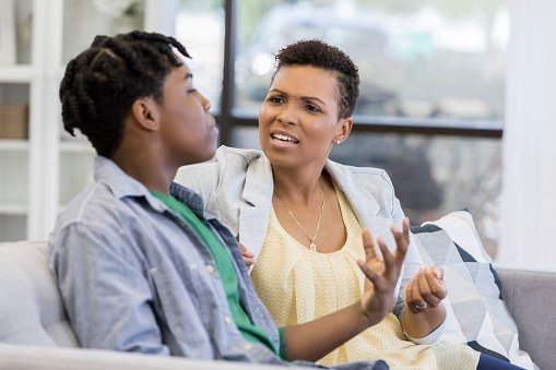 Mom and her teenage son pictured arguing at home. | Photo: Getty Images