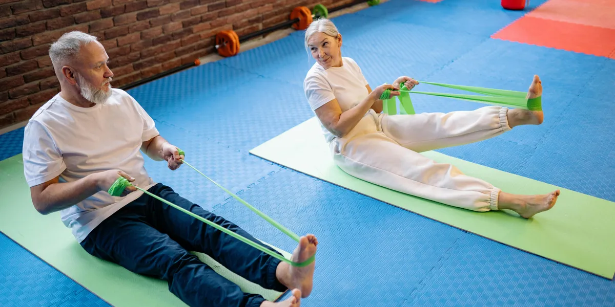 Elderly couple using resistance bands | Source: Pexels