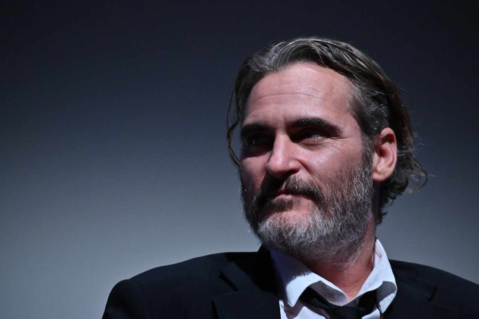 On October 2, 2019, Joaquin Phoenix attended the 57th New York Film Festival, embodying his intense, brooding style in a dark suit and open collar as he discussed his work in “Joker.” | Source: Getty Images