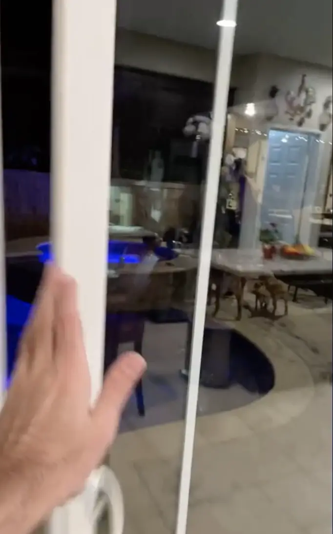 A close-up shot of Austin sliding the door that opens into his backyard, as seen in a video dated February 24, 2021 | Source: TikTok/@snow5_0
