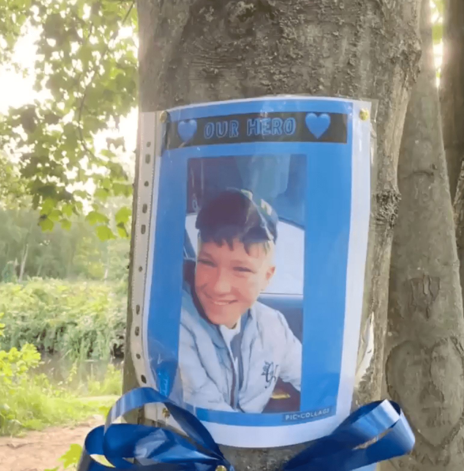A photograph of a youngster who drowned is placed on a tree to honor him as a hero | Photo: Twitter/GHR_Derbyshire 