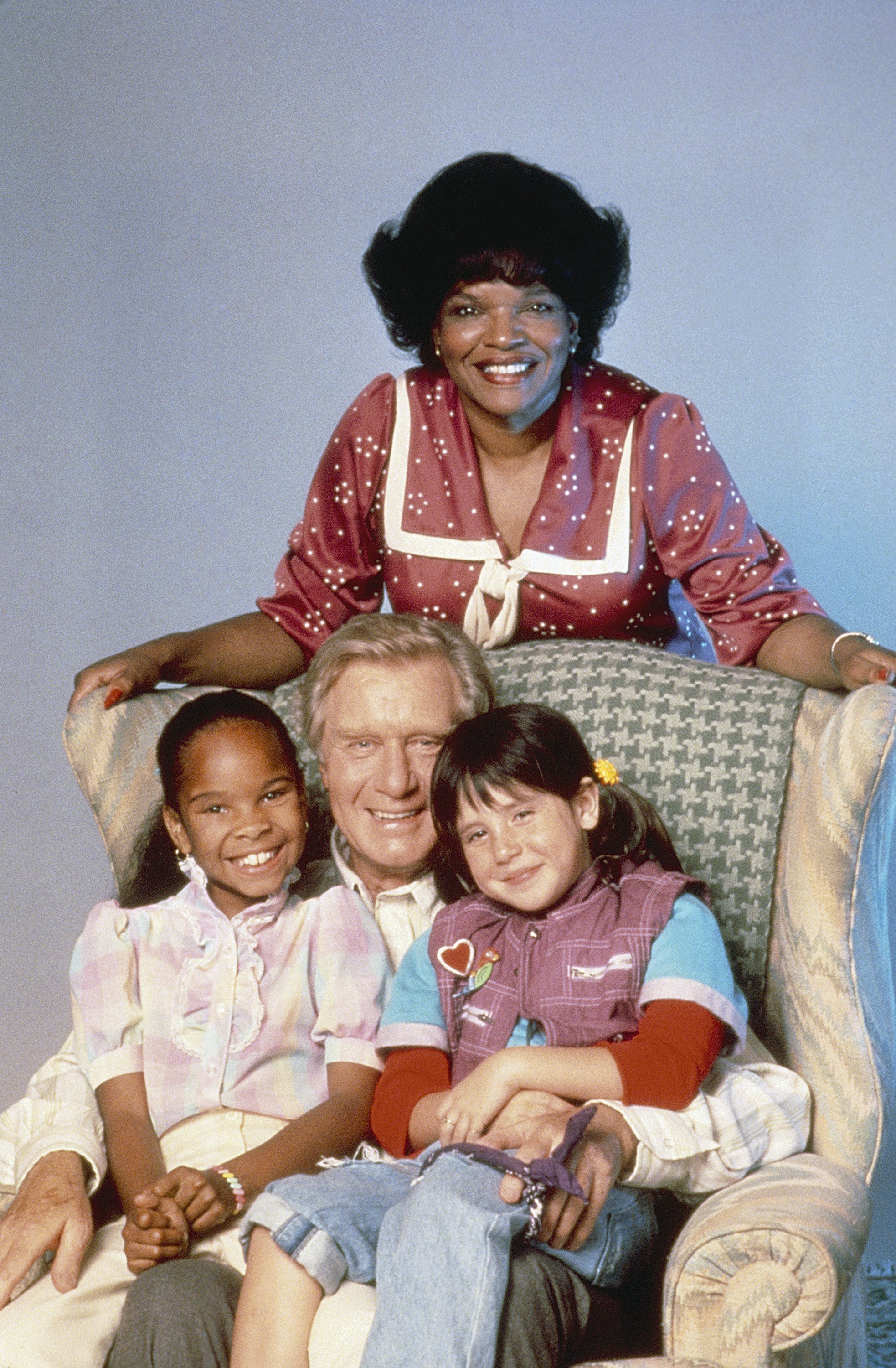 Susie Garrett, Cherie Johnson, George Gaynes and Soleil Moon  Frye in a promo shoot for "Punky Brewster" season 1 in 1984 | Photo: Getty Images 