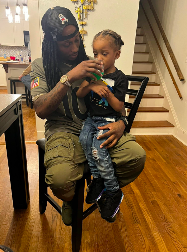 Todd Reliford giving his son Elias Reliford something to drink, posted on September 2, 2025. | Source: Facebook/Todd Reliford