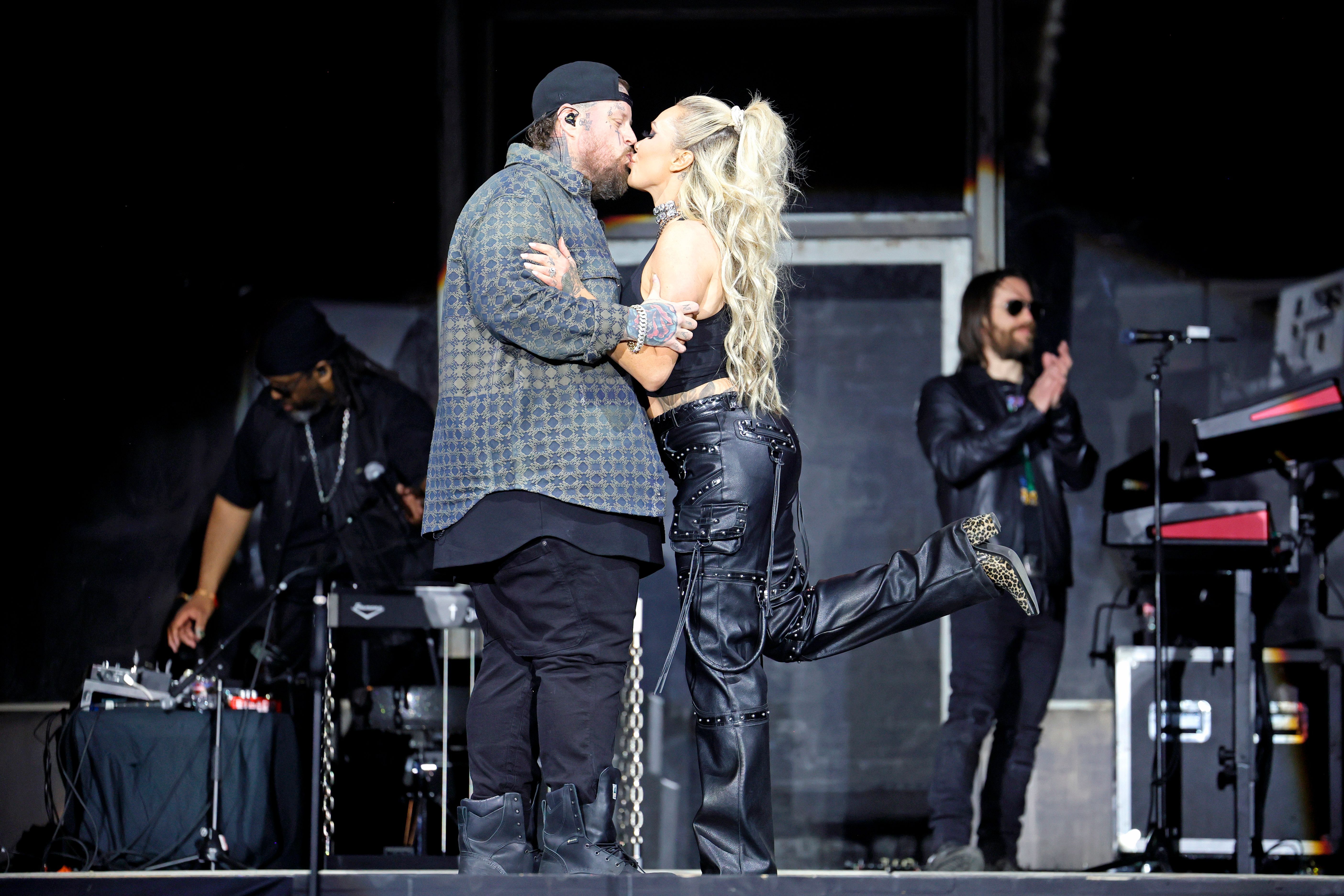 Jelly Roll and Bunnie XO share a kiss onstage during a performance, offering a glimpse of the affectionate partnership they often displayed publicly. The image has taken on new meaning after reports revealed the pair, who are divorcing after nearly 10 years of marriage, had "always had a complicated dynamic. | Source: Getty Images