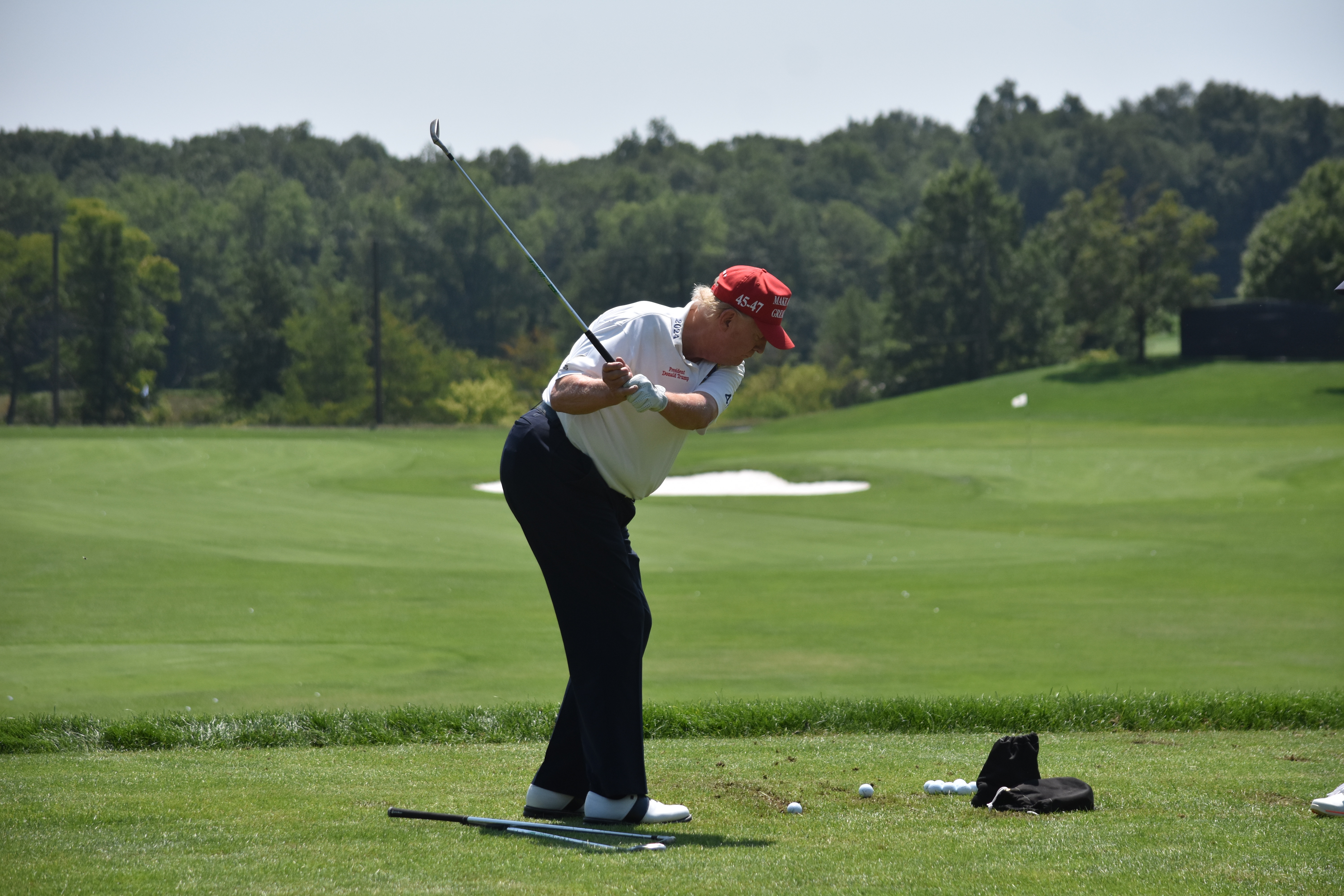 Donald Trump plays golf at the driving range at LIV Golf Bedminster 2023 Event in Bedminster, New Jersey, on August 9, 2023 | Source: Getty Images