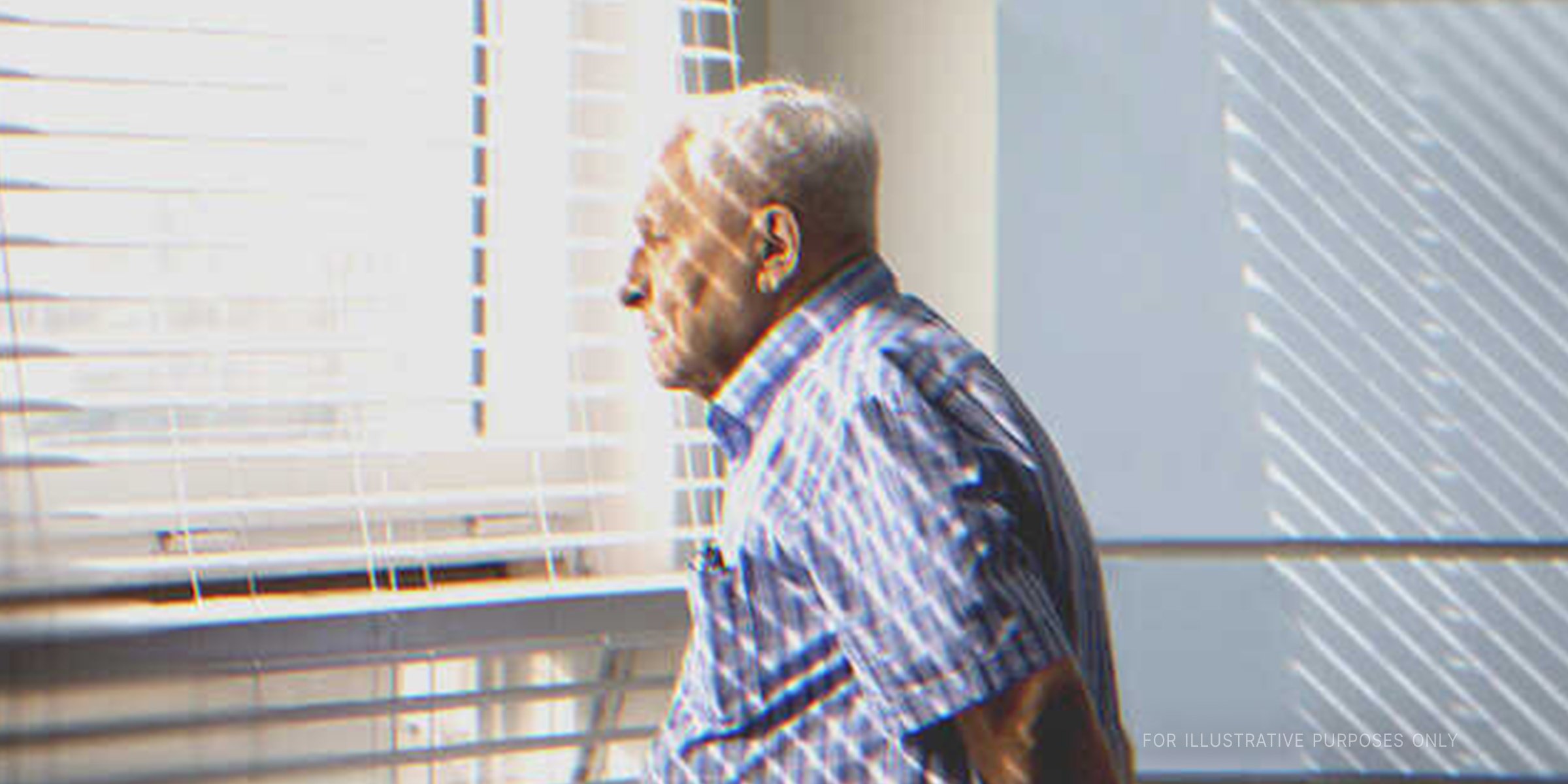 Old man looking through window. | Shutterstock