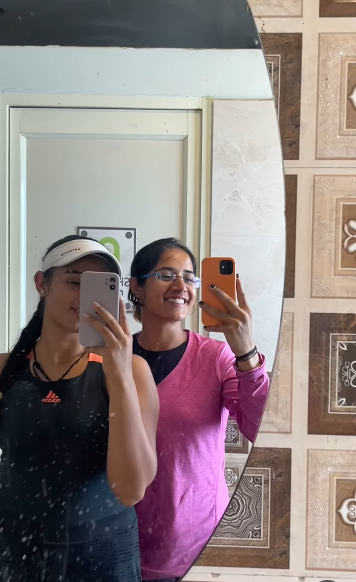 Radhika Yadav and her best friend taking selfies and recording videos in front of a mirror, from a clip posted by her best friend, Himaanshika Singh Rajput, on July 12, 2025 | Source: Instagram/himaanshika