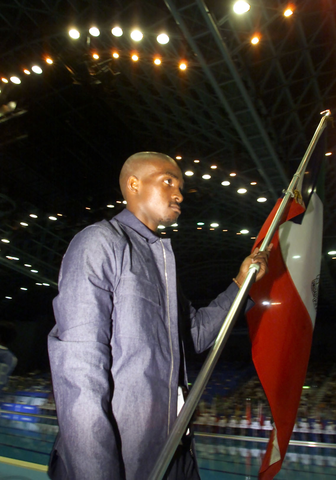 Eric Moussambani carries Equatorial Guinea's national flag at the Opening Ceremony of the World Swimming Championships in the Marine Messe, Fukuoka, Japan, on July 20, 2001 | Source: Getty Images