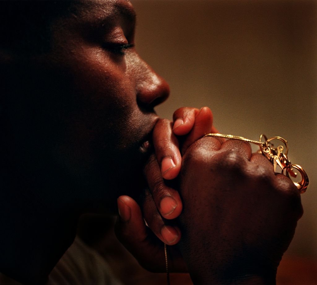 Al Joyner, husband of the late olympic gold medalist Florence Griffith Joyner, keeps her rings close to his heart, strung on his gold chain. Photo taken at his Mission Viejo home Oct. 21, 1998. | Source: Getty Images
