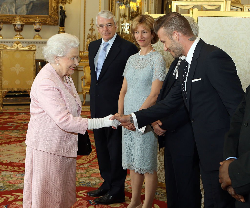 Queen Elizabeth II met David Beckham at a reception at Buckingham Palace, in London in 2015. | Source: Getty Images