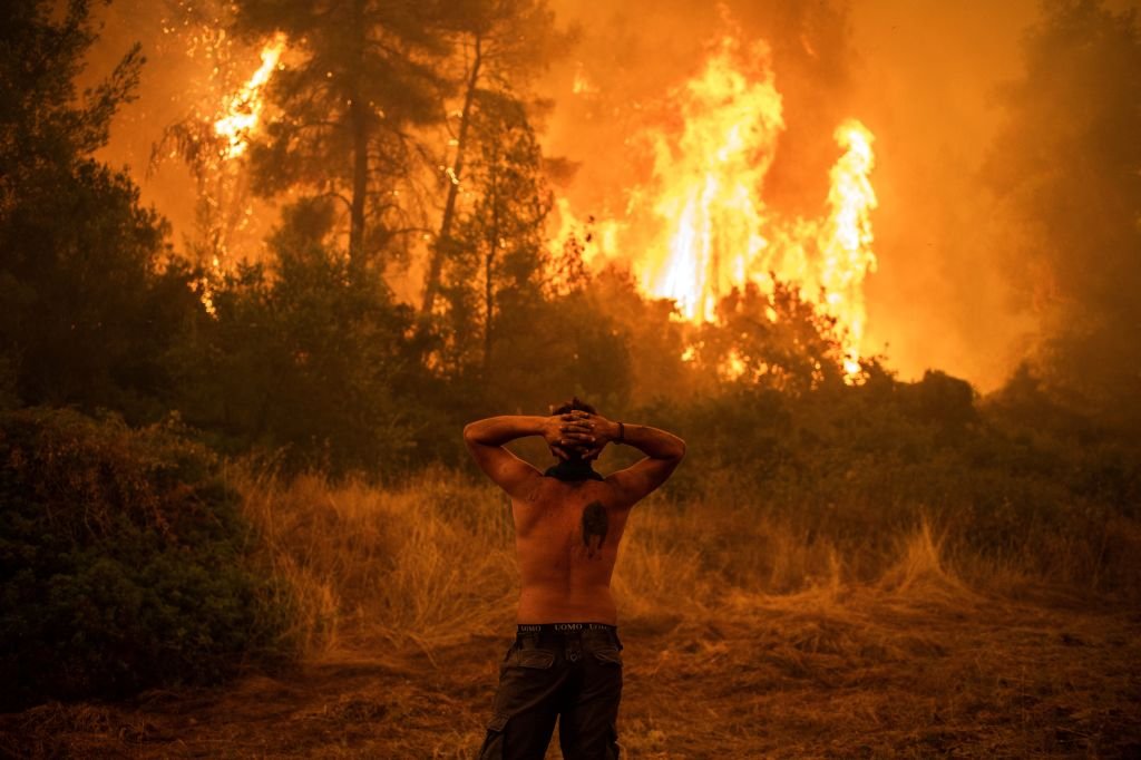 A man stared at the wildfire and it approached the village of Pefki on Evia (Euboea) island, Greece's second largest island. August 8, 2021 | Source: Getty Images