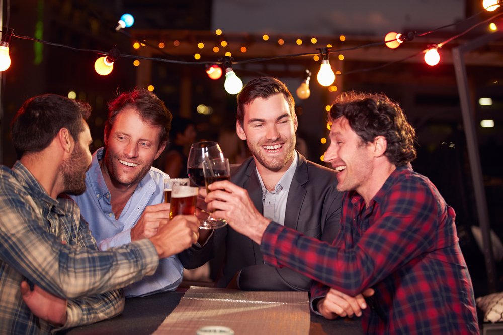 A photo of four men drinking. | Photo: Shutterstock