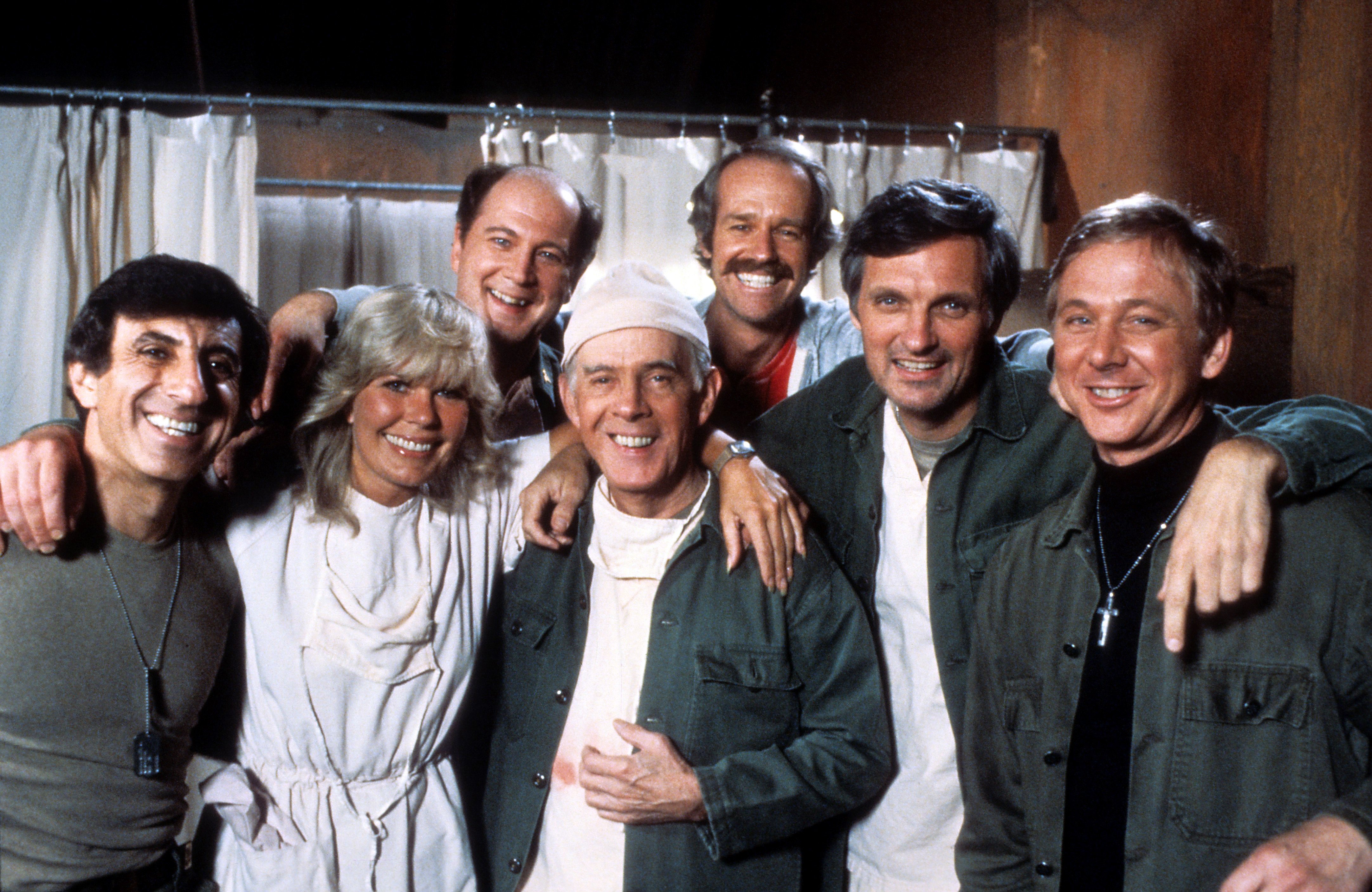 Jamie Farr, Loretta Swit, David Ogden Stiers, Harry Morgan, Mike Farrell, Alan Alda, and William Christopher in a portrait for the comedy series "M*A*S*H" in 1978. | Source: Getty Images
