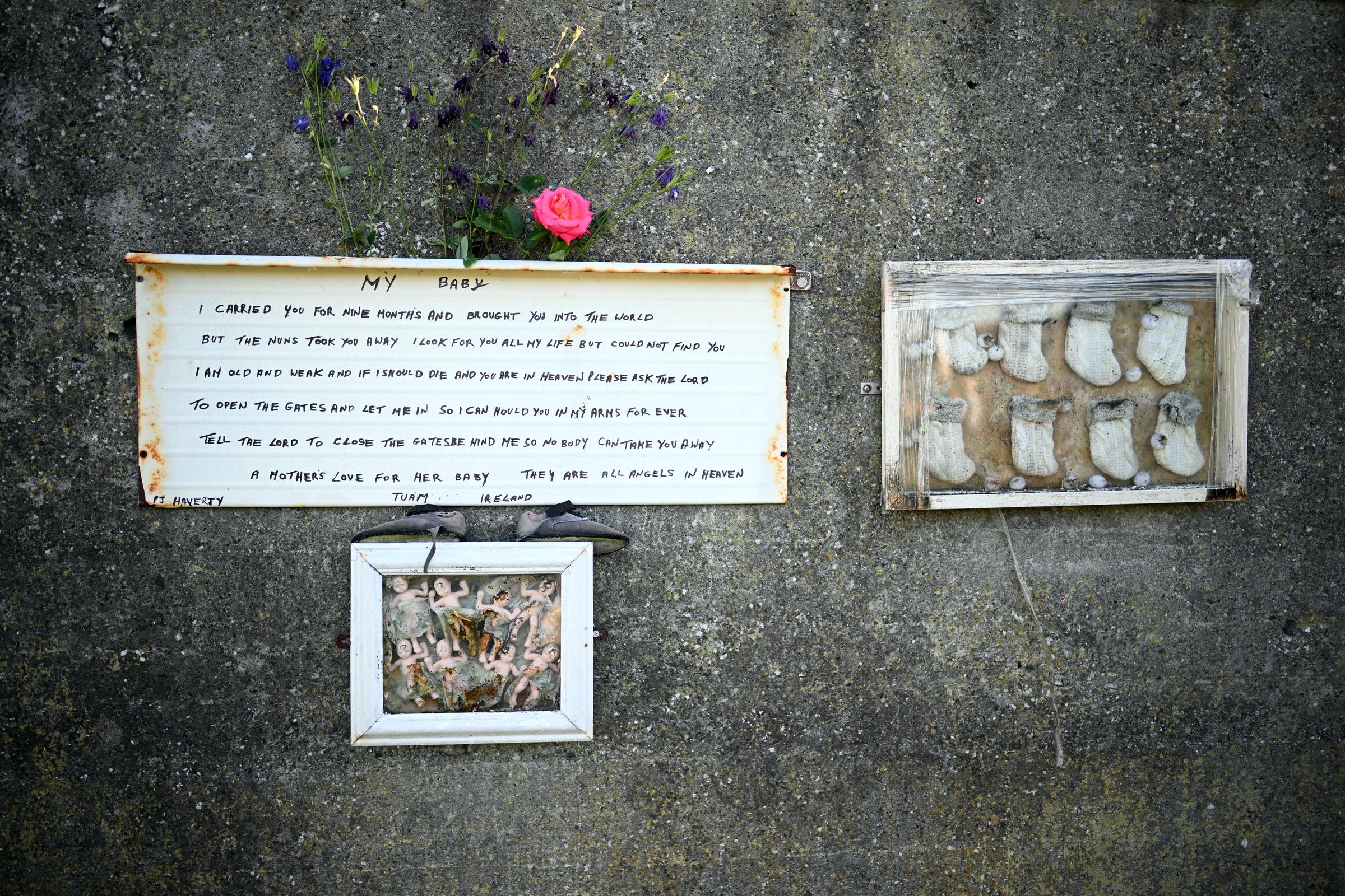 Mementos and a poem written by a survivor of the home can be seen at the former site of the Bon Secours Mother and Baby home and the memorial garden, dated March 21, 2025 | Source: Getty Images