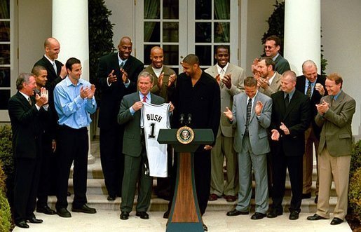 Tim Duncan and the Spurs at the White House with President George Bush after winning the 2003 NBA Finals| Source: Wikimedia