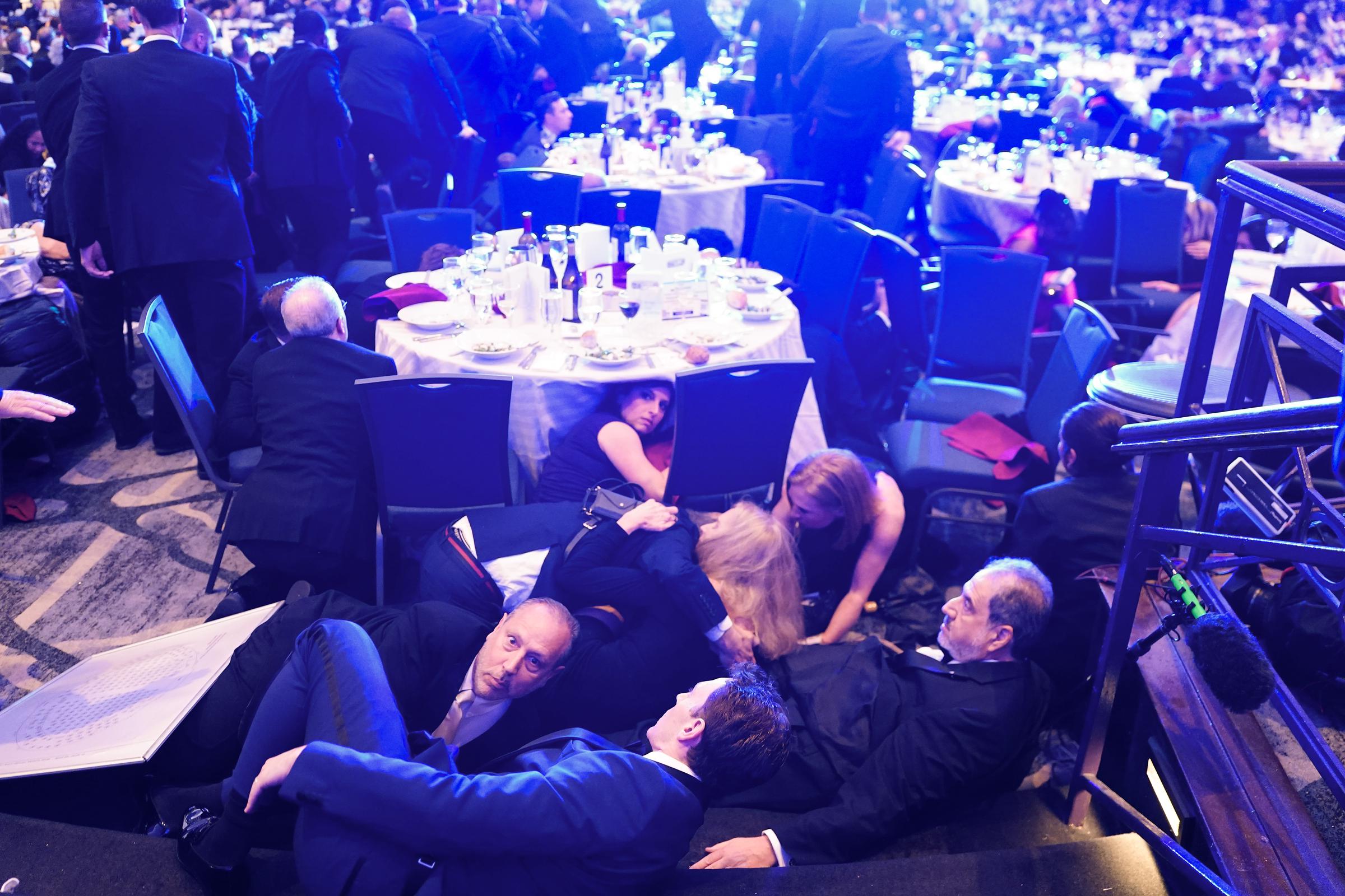 Guests take cover after gun fire erupted during the annual White House Correspondents Association Dinner on April 25, 2026 | Source: Getty Images