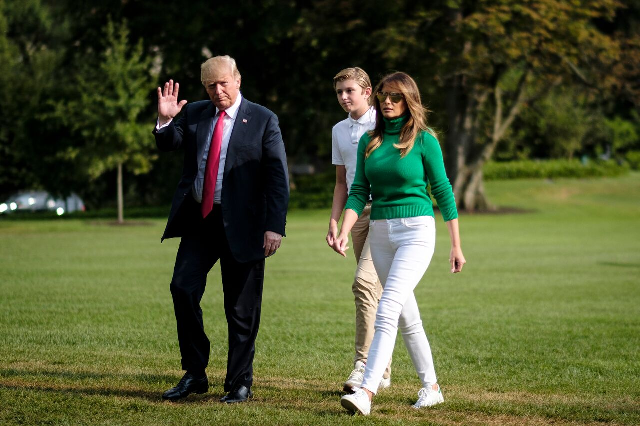 Donald Trump disembarks from Marine One on the South Lawn with First Lady Melania Trump and his son Barron. | Source: Getty Images