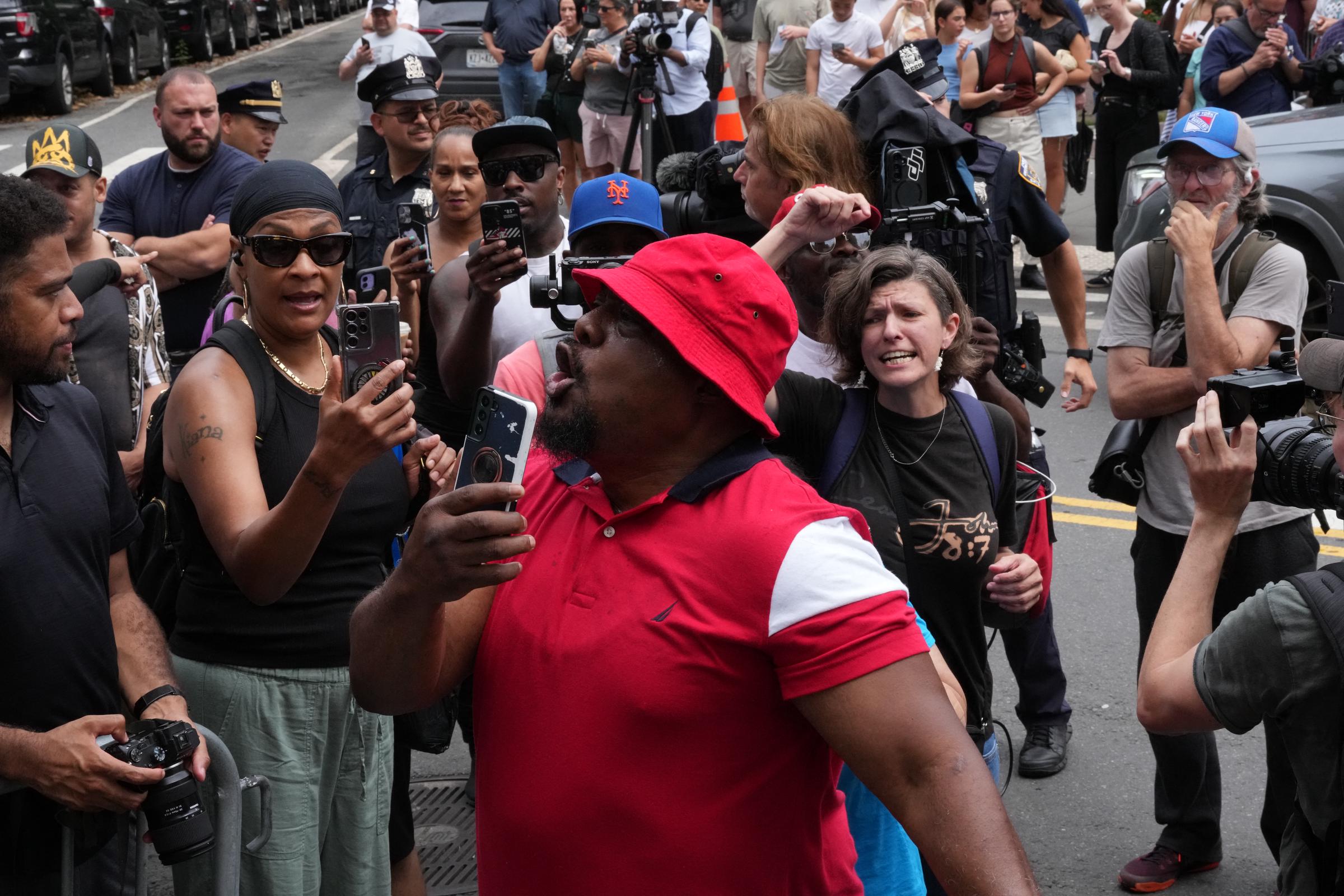 Outside the court, tensions flare as people voice opposing views following the verdict in Sean “Diddy” Combs’ trial. Emotions run high with shouting, filming, and raised fists.